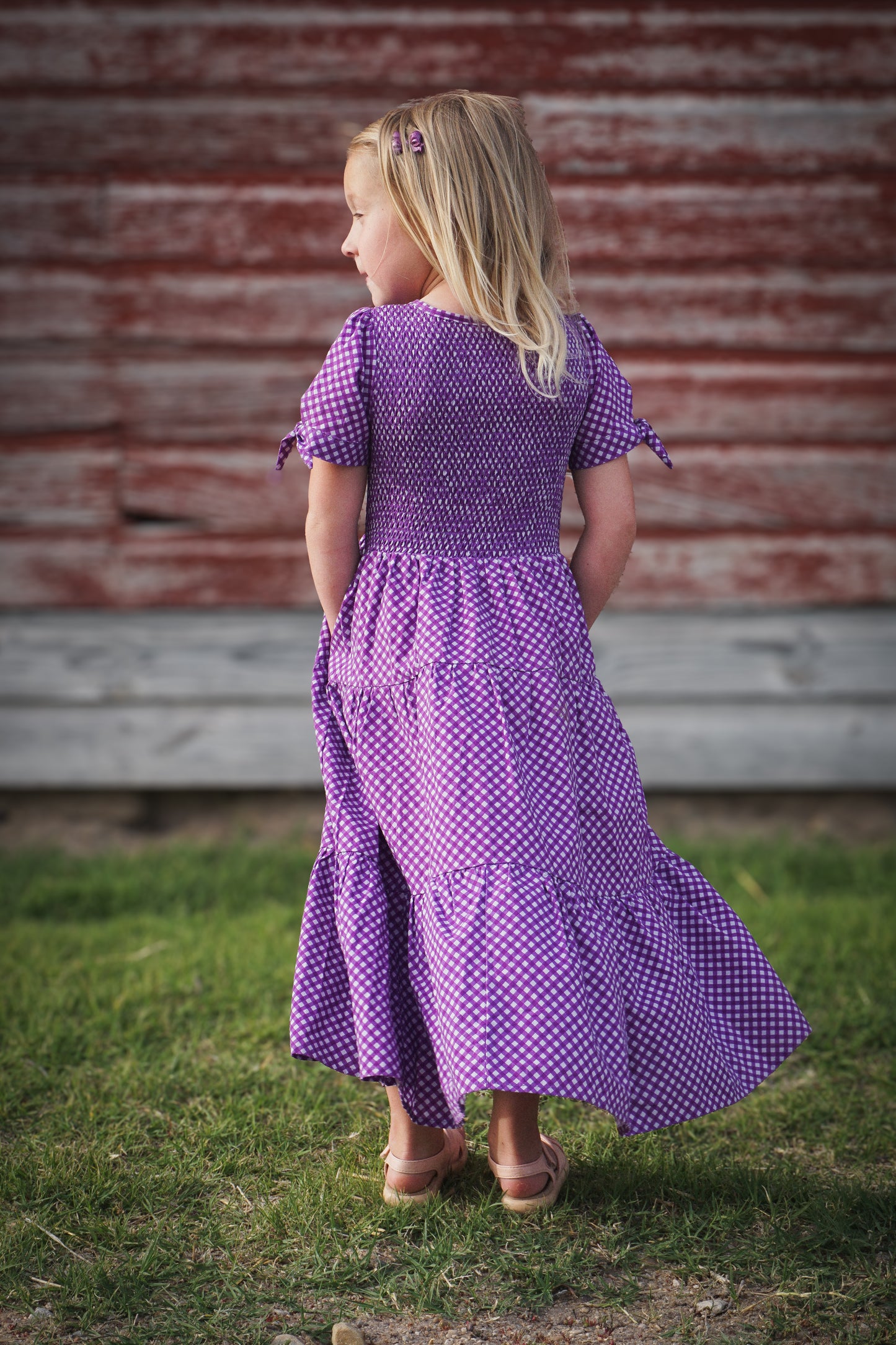 Young girl wearing a modest purple dress