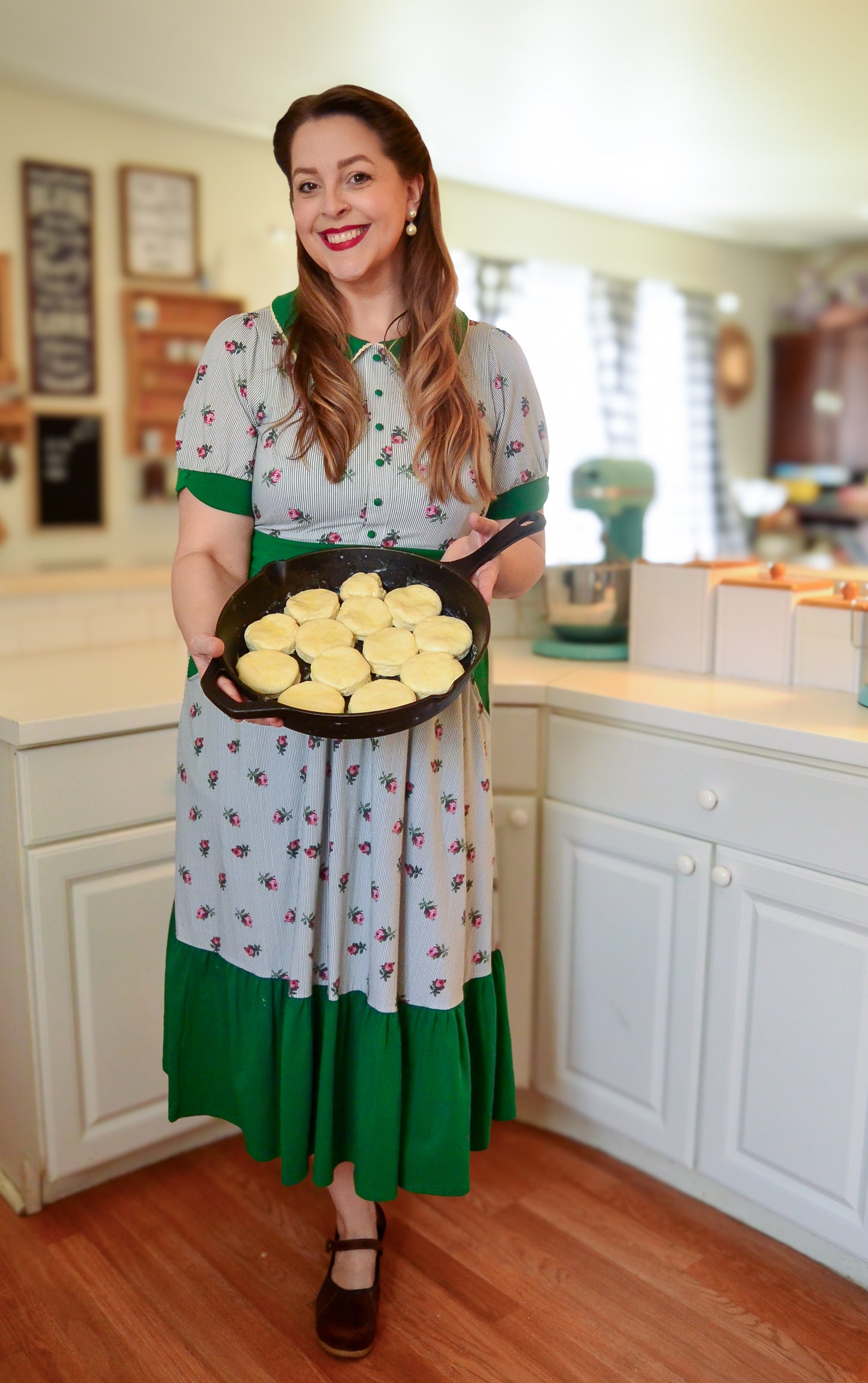 woman wearing a green and white striped modest nursing dress