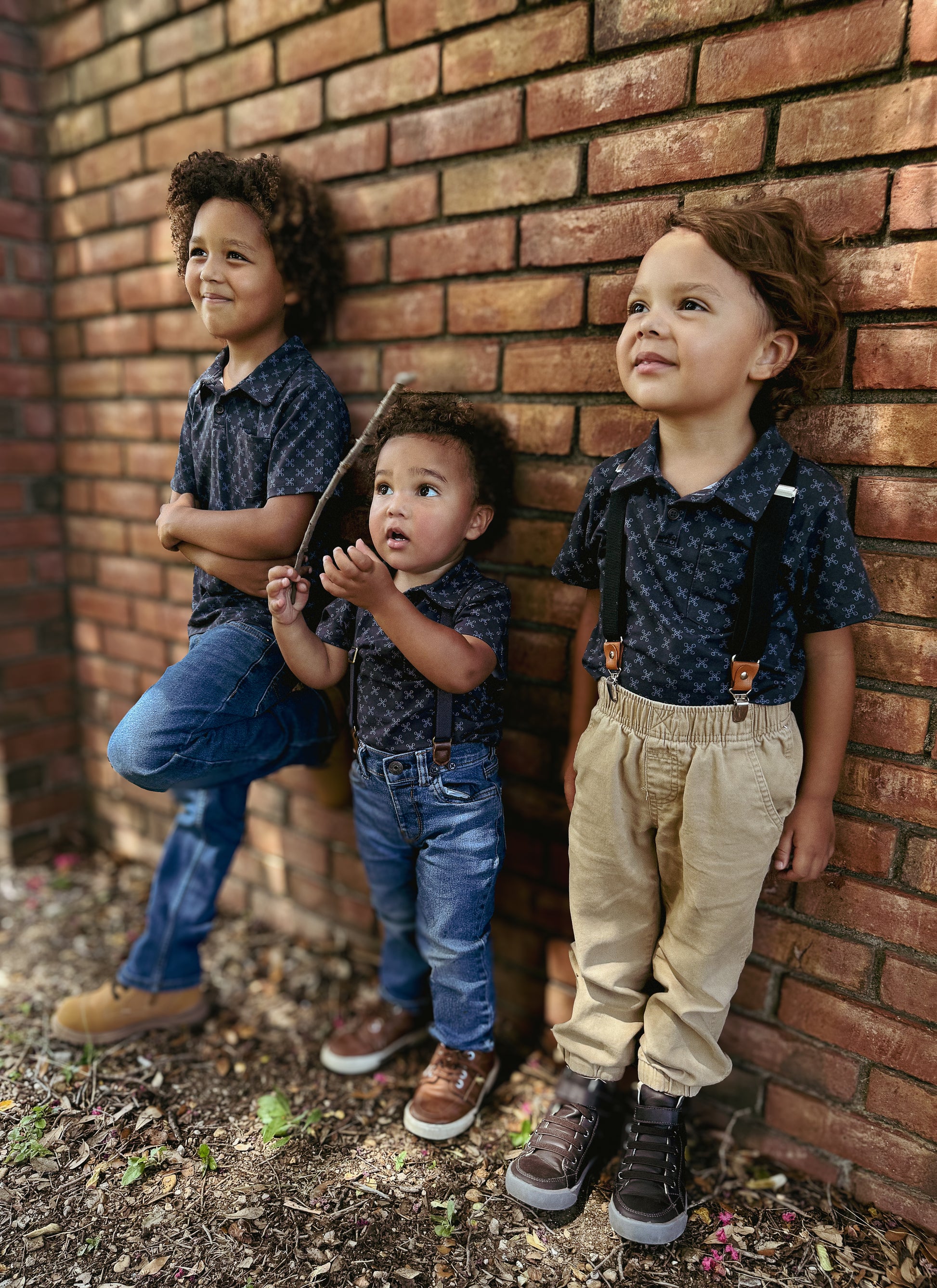 Young boys wearing a dark blue polo shirt