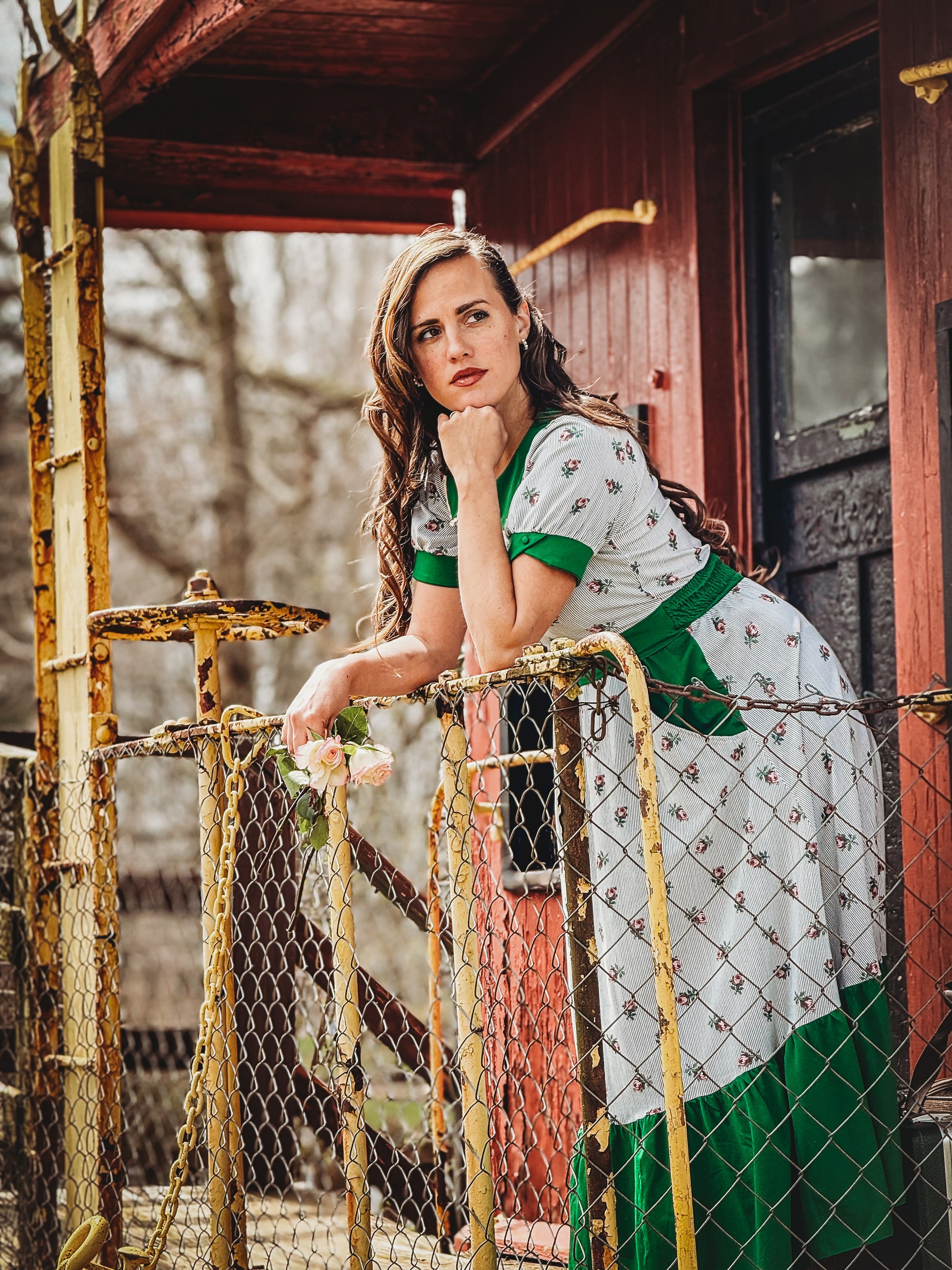 woman wearing a green and white striped modest nursing dress
