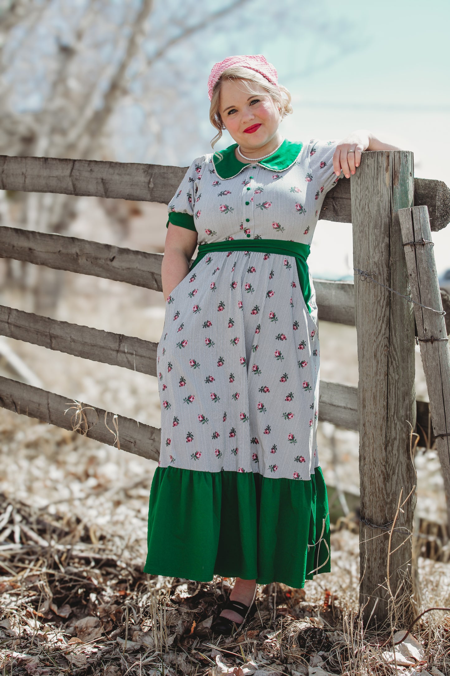 woman wearing a green and white striped modest nursing dress