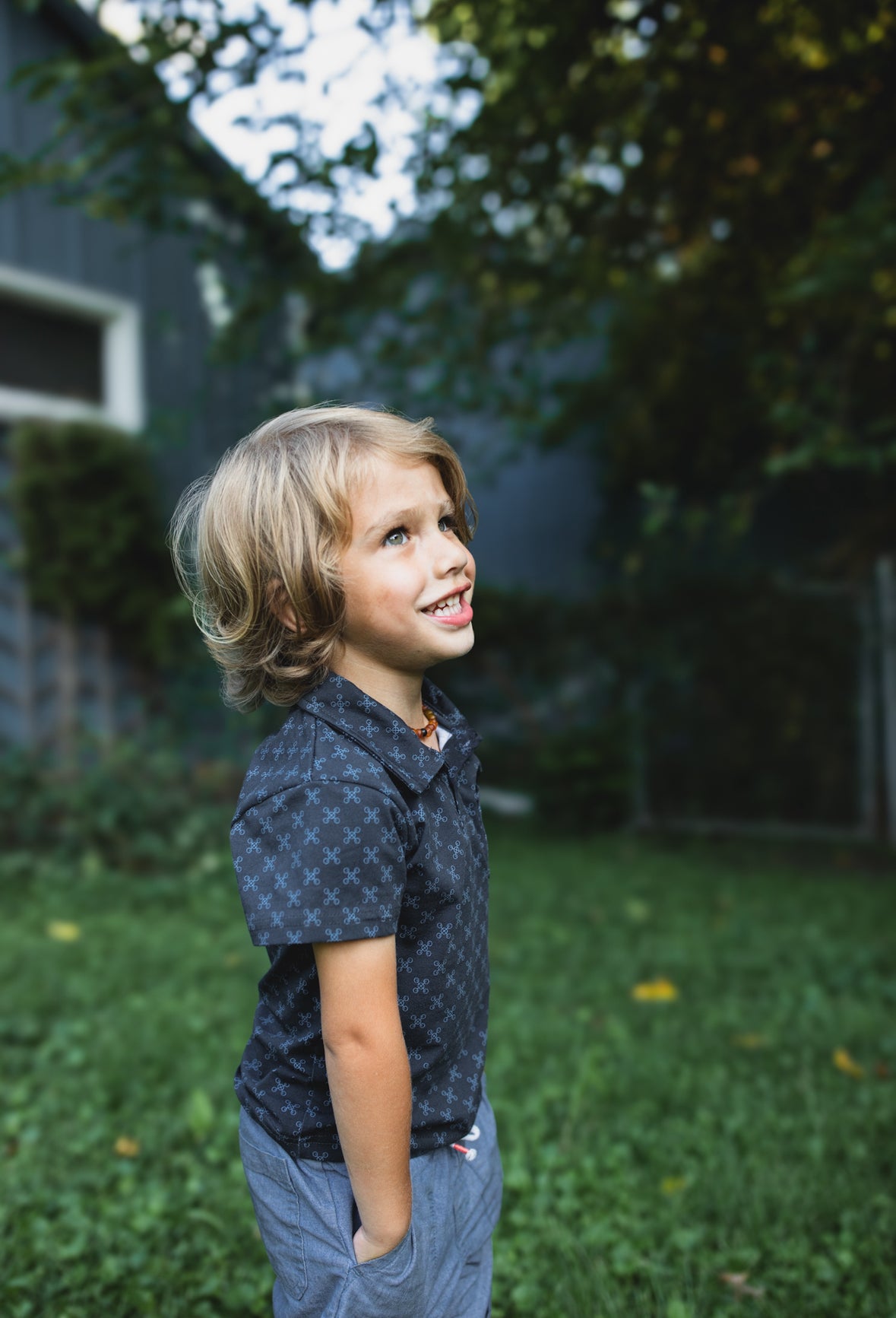 Young boy wearing a dark blue polo shirt