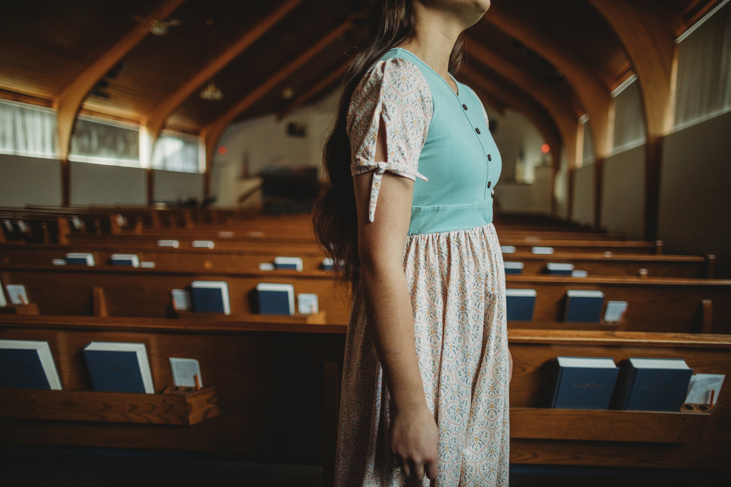 A woman wearing a vintage style modest nursing dress.