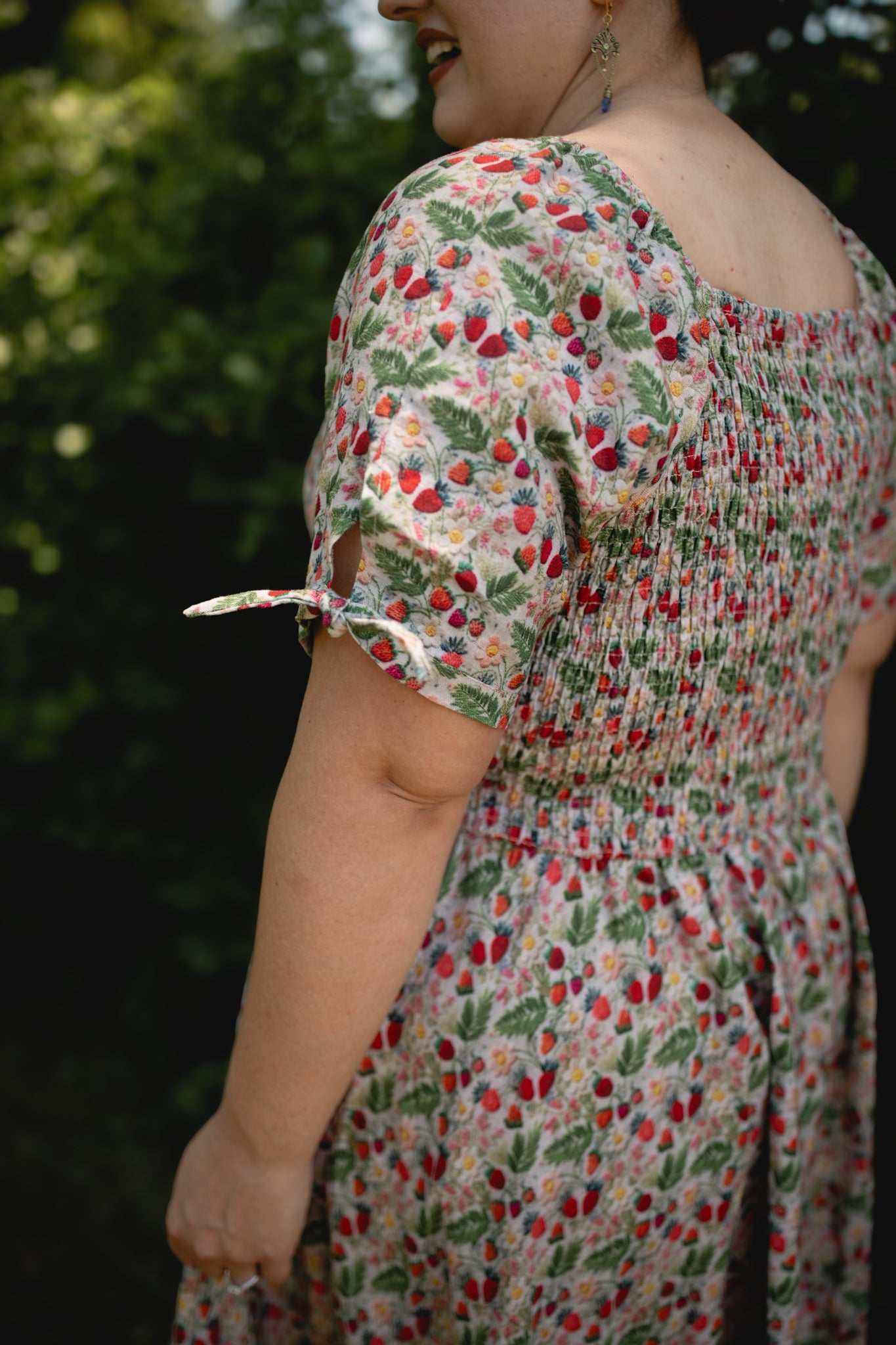 Person wearing a floral modest nursing dress with a blurred background