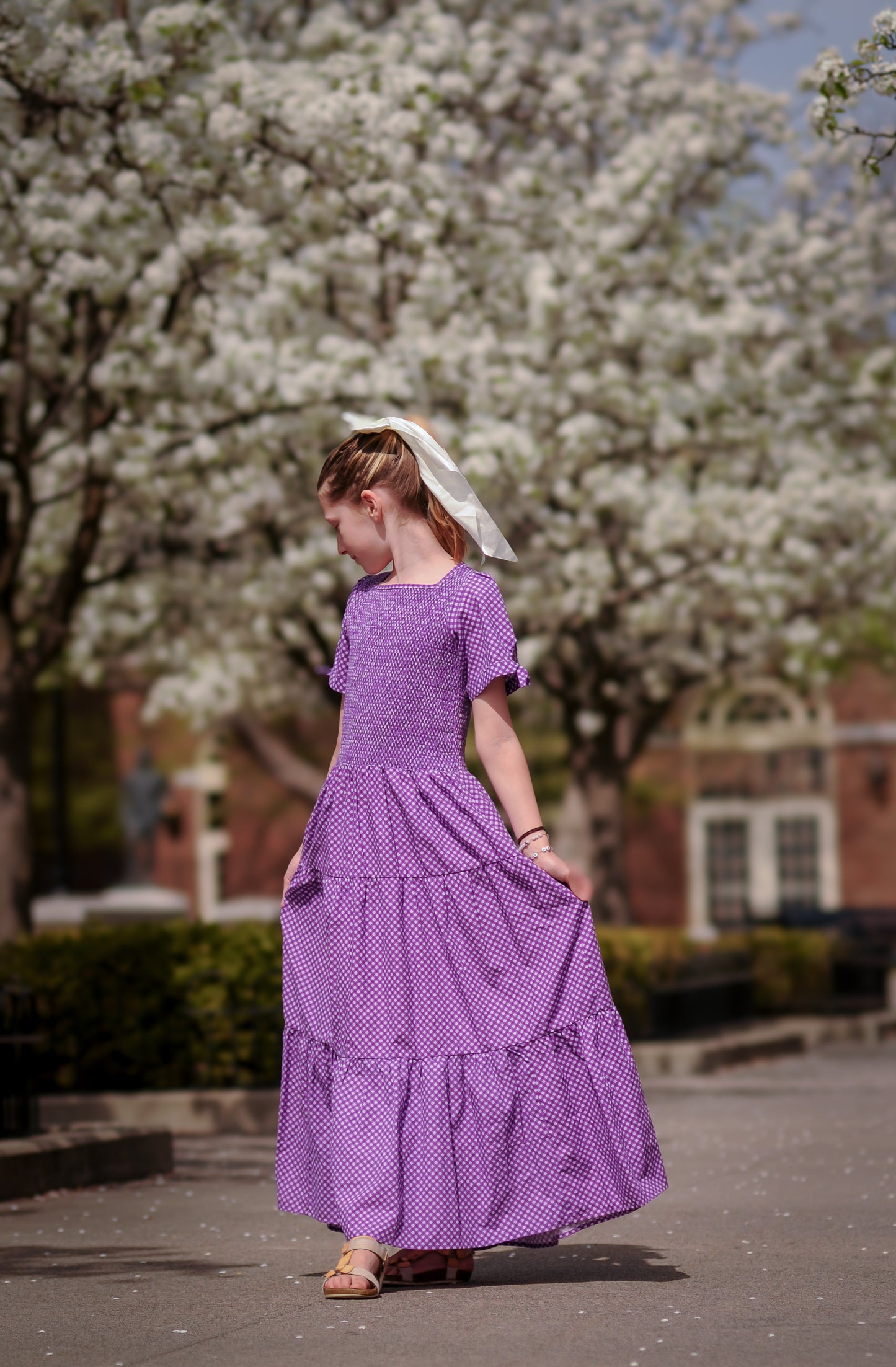 Young girl wearing a modest purple dress