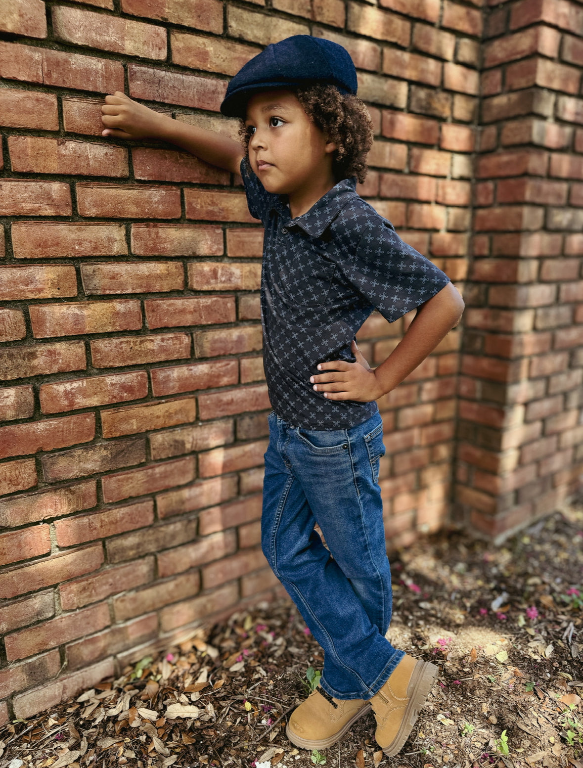 Young boy wearing a dark blue polo shirt