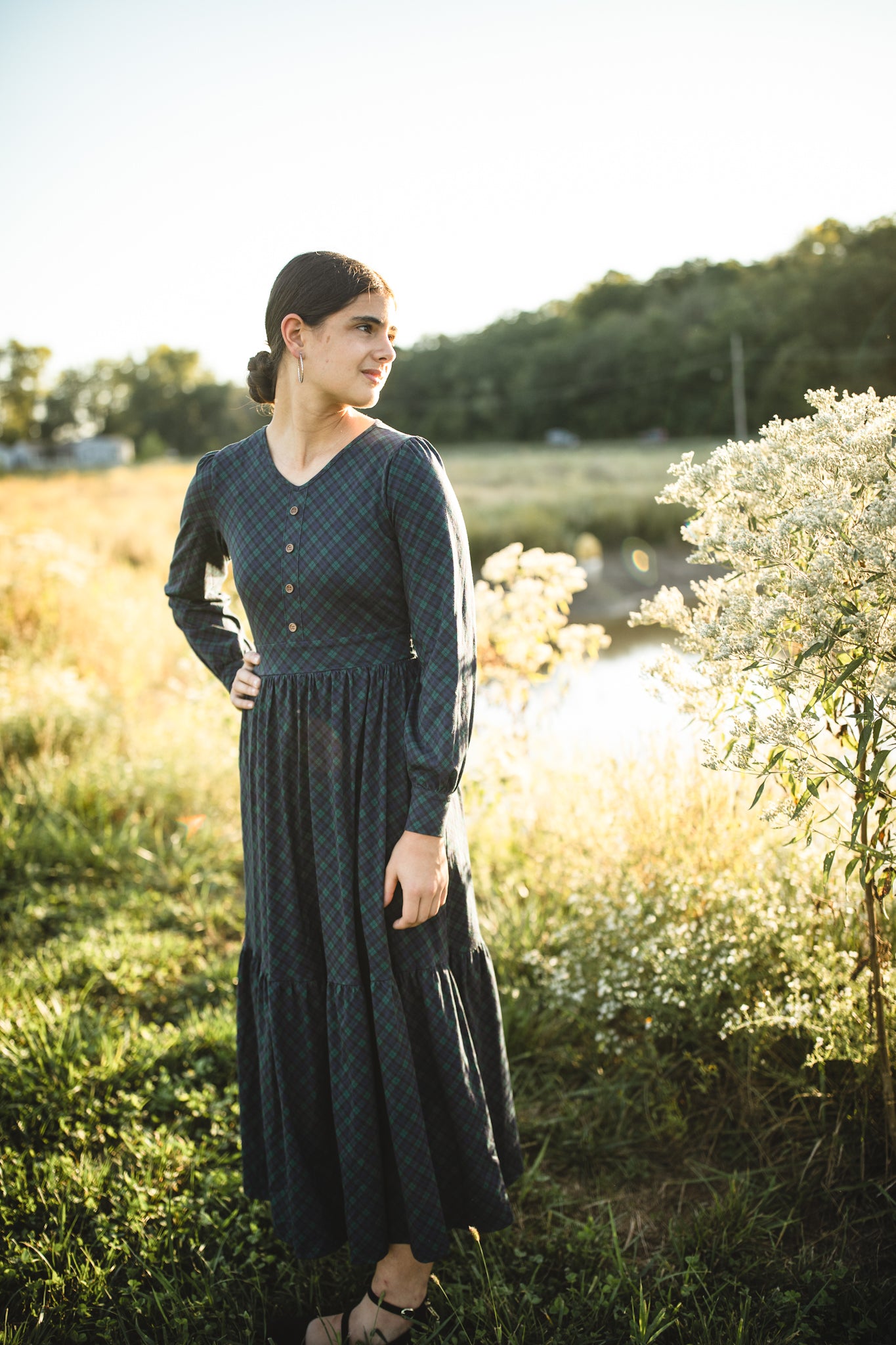 Woman in modest nursing dress outdoors sunlight