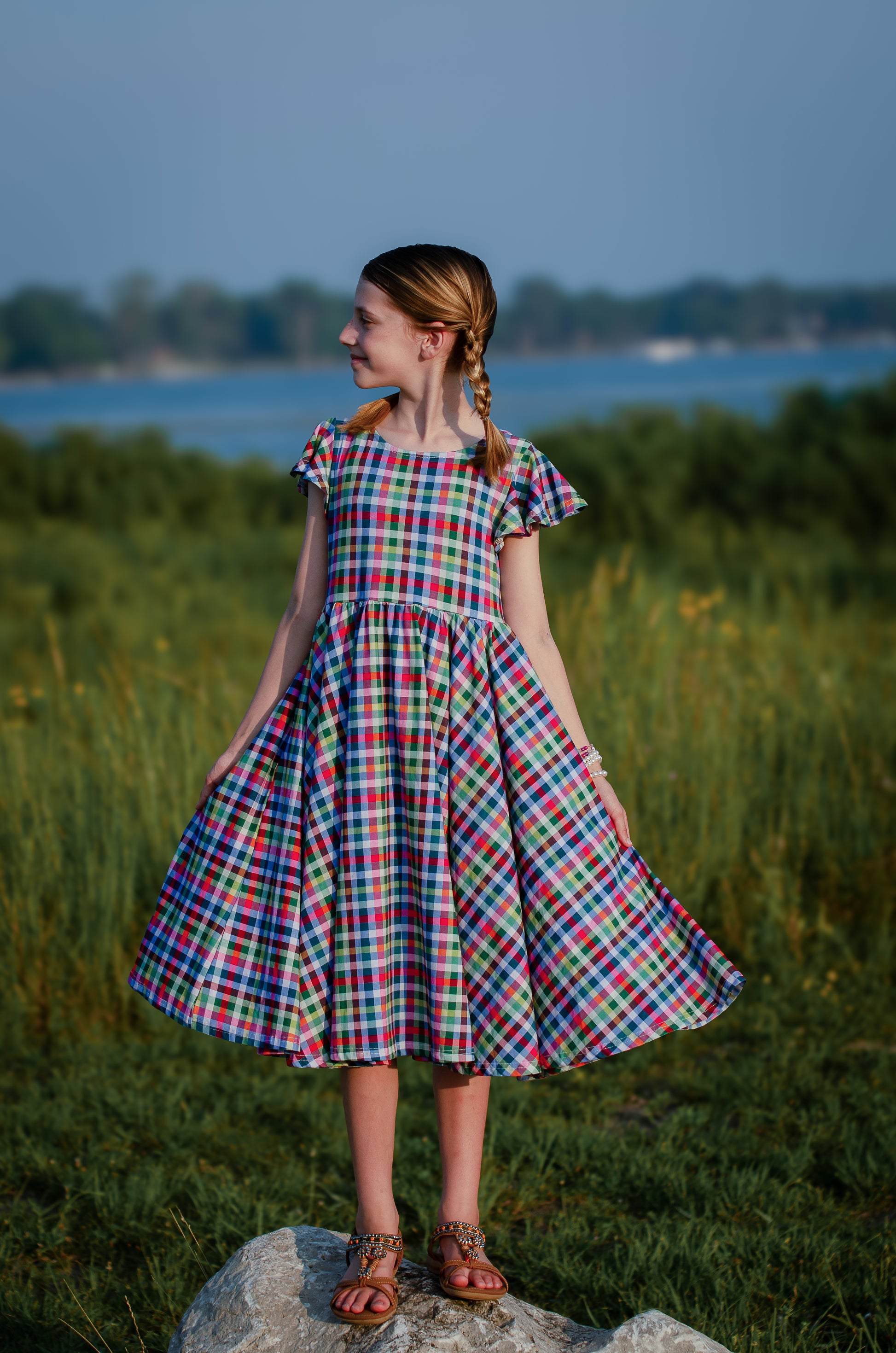 Young girl in a colorful checkered modest dress