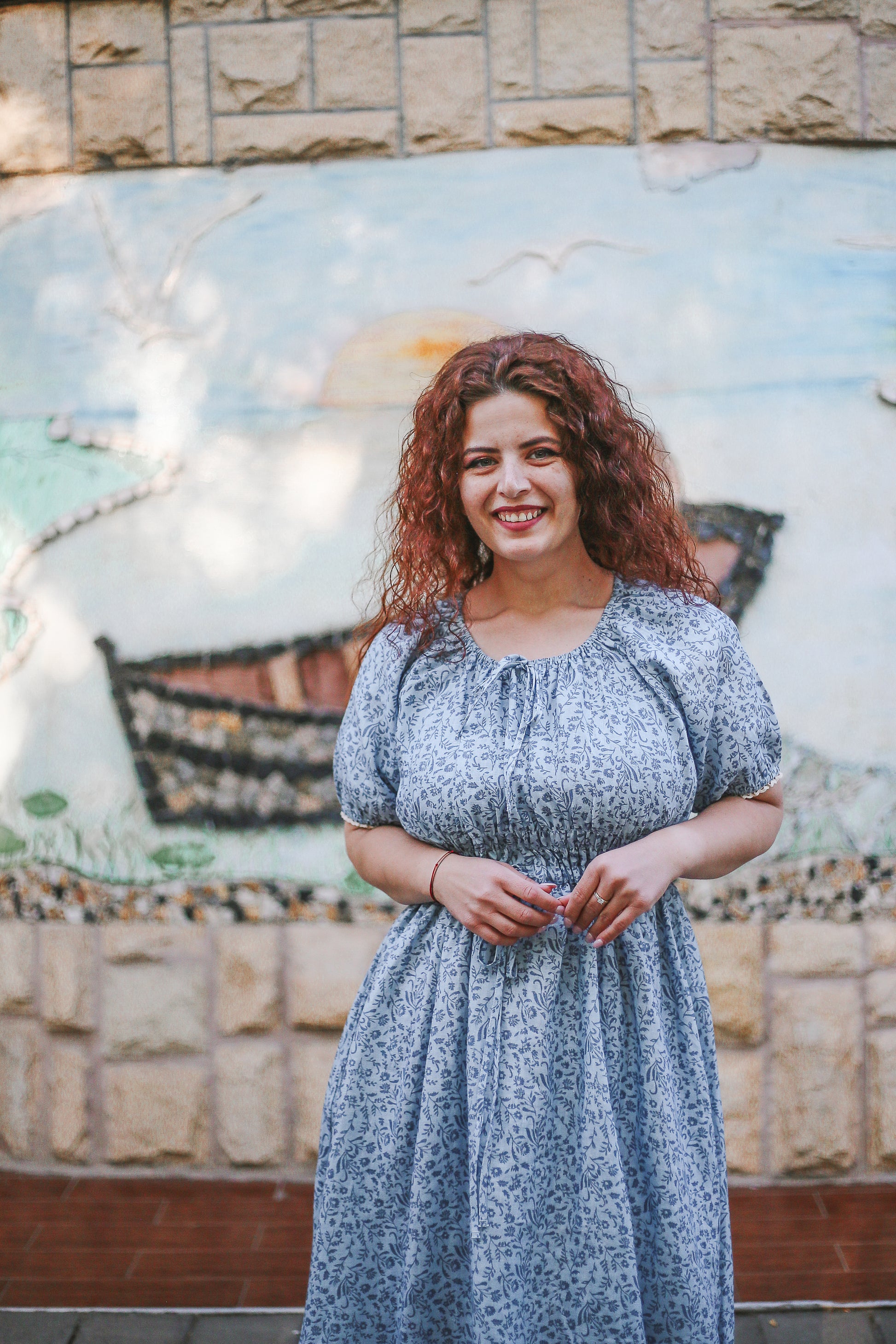 woman in a modest blue nursing dress