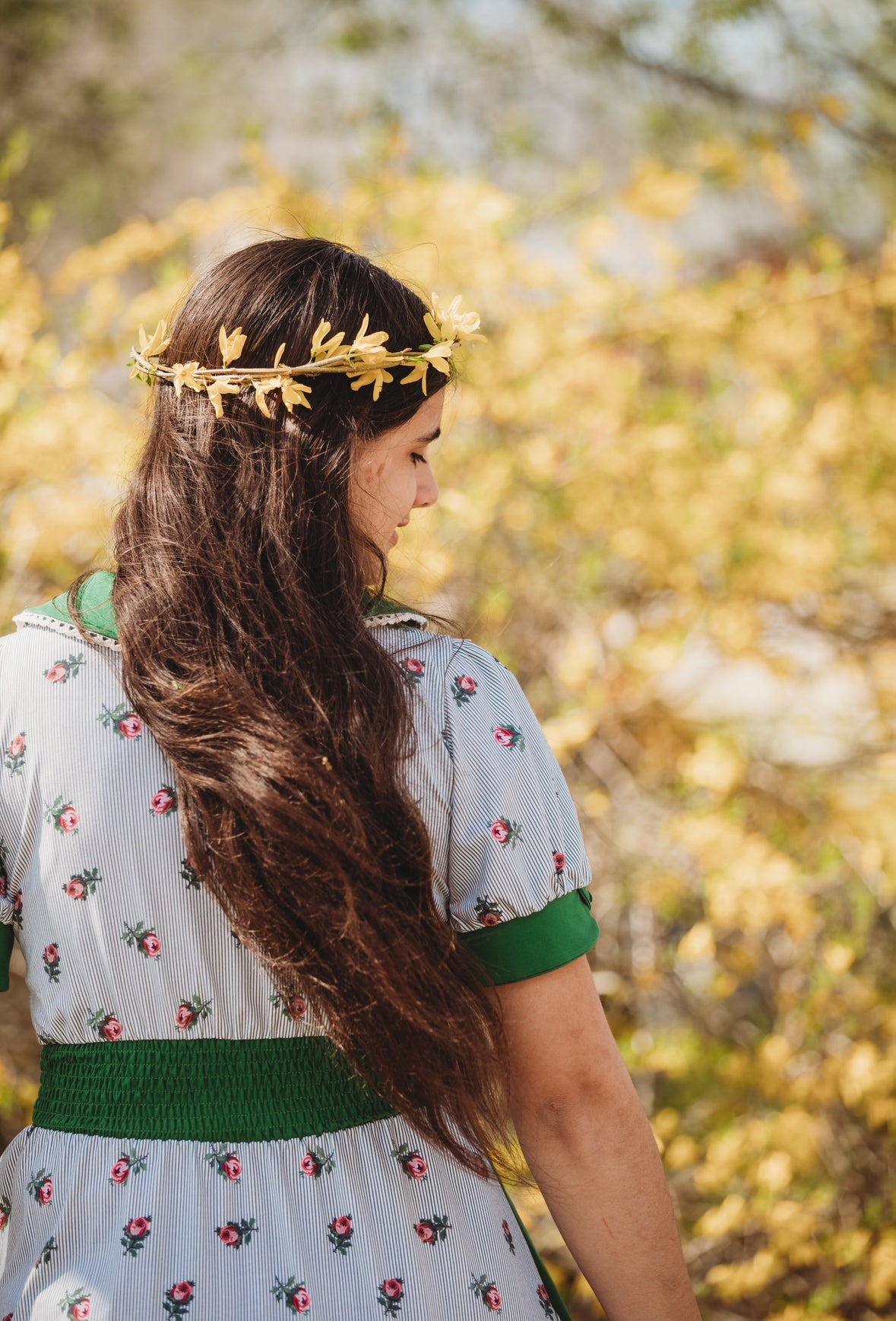 woman wearing a green and white striped modest nursing dress
