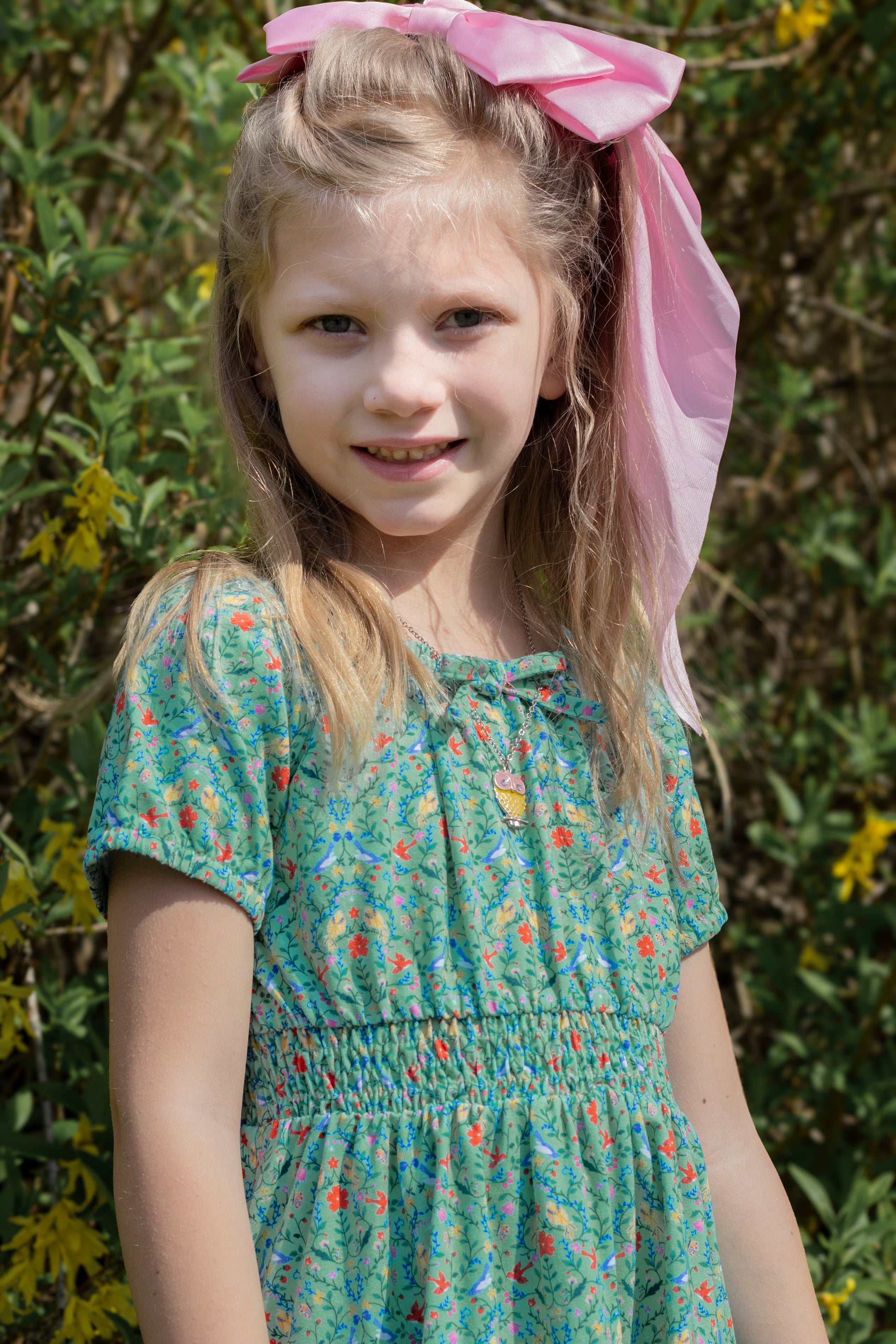 Young girl wearing a modest green dress