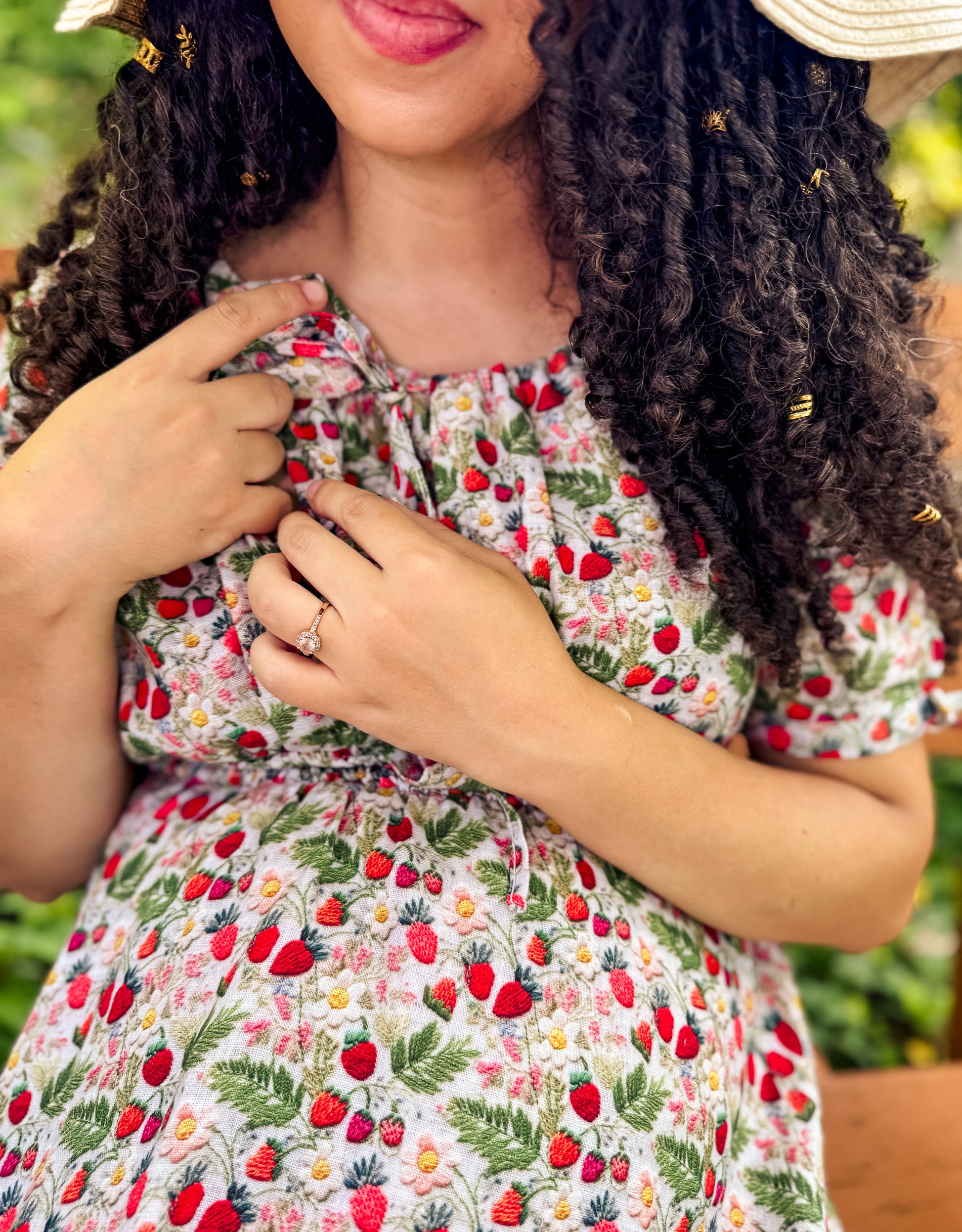 Woman wearing a floral modest nursing dress with a ring, outdoors.
