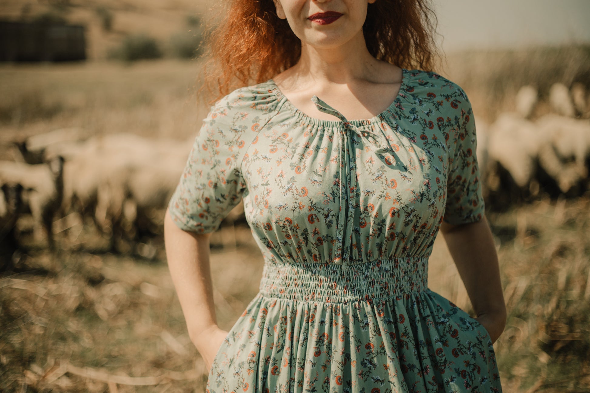 Woman in modest nursing floral dress with sheep