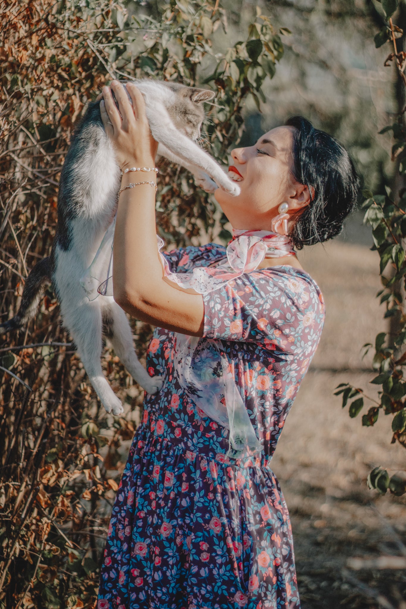 woman wearing a modest nursing floral dress with her cat