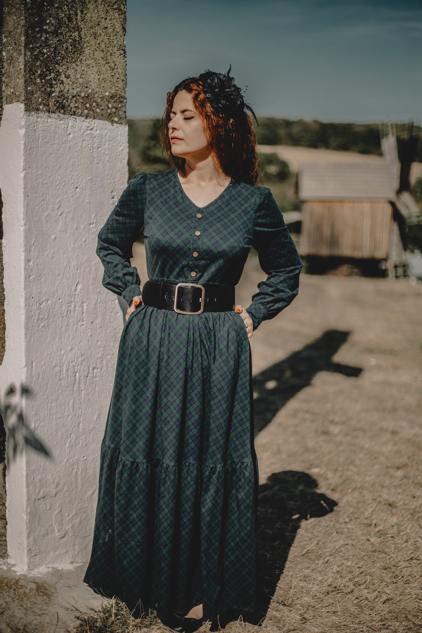 Woman in modest nursing dark green dress outdoors