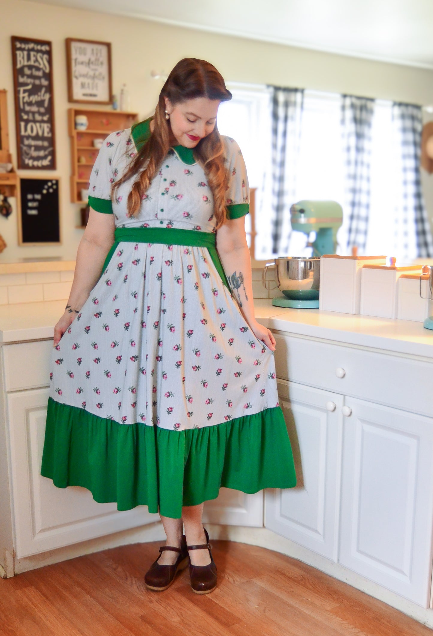 woman wearing a green and white striped modest nursing dress