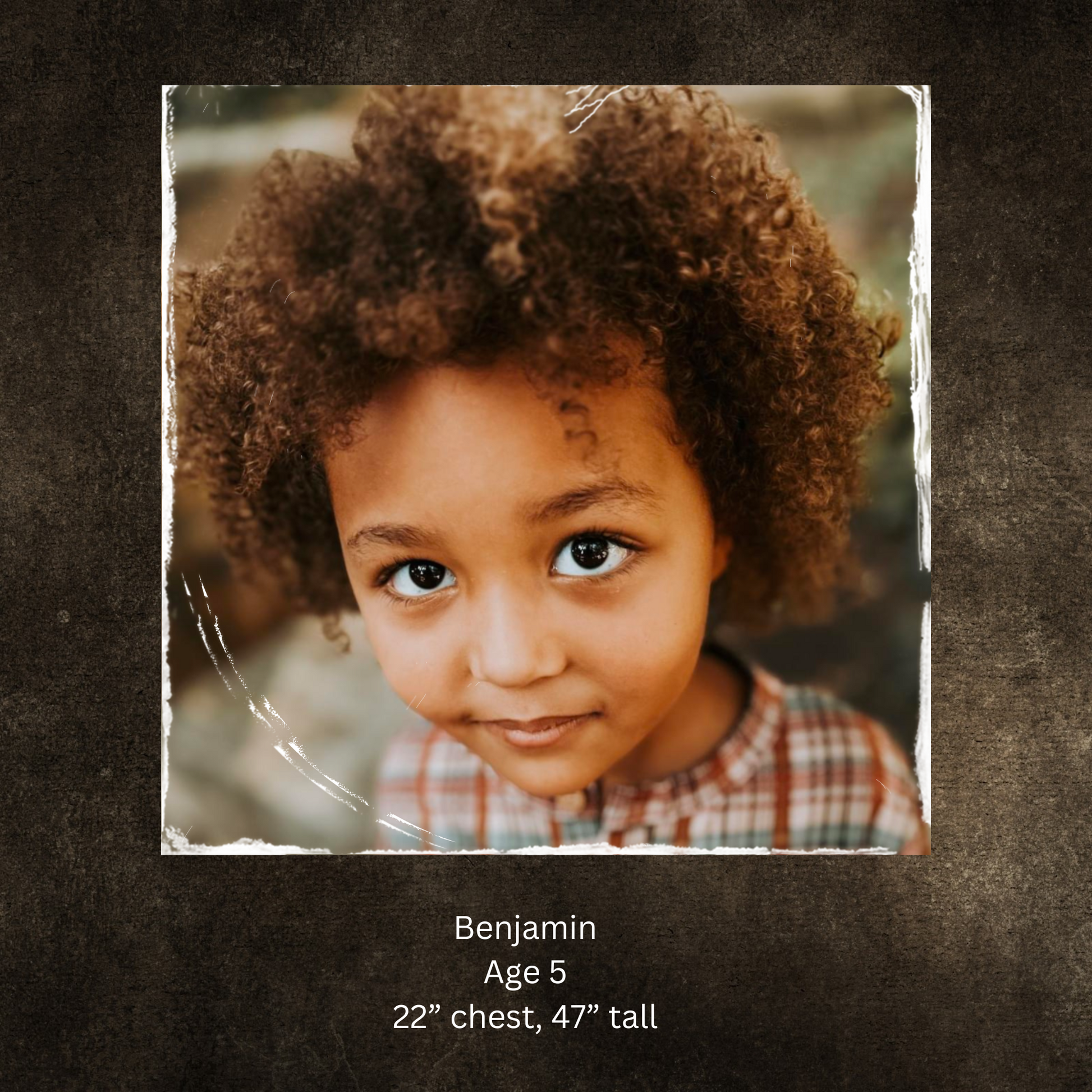Child with curly hair on dark background