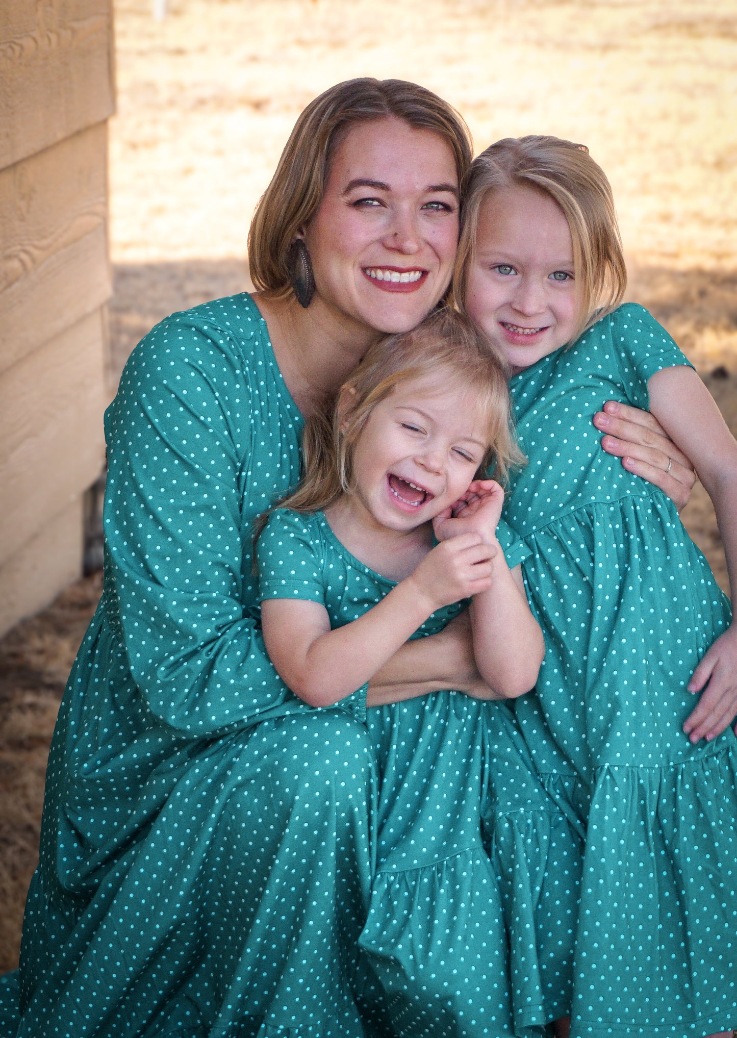 woman wearing modest nursing dress with her daughters wearing matching dresses