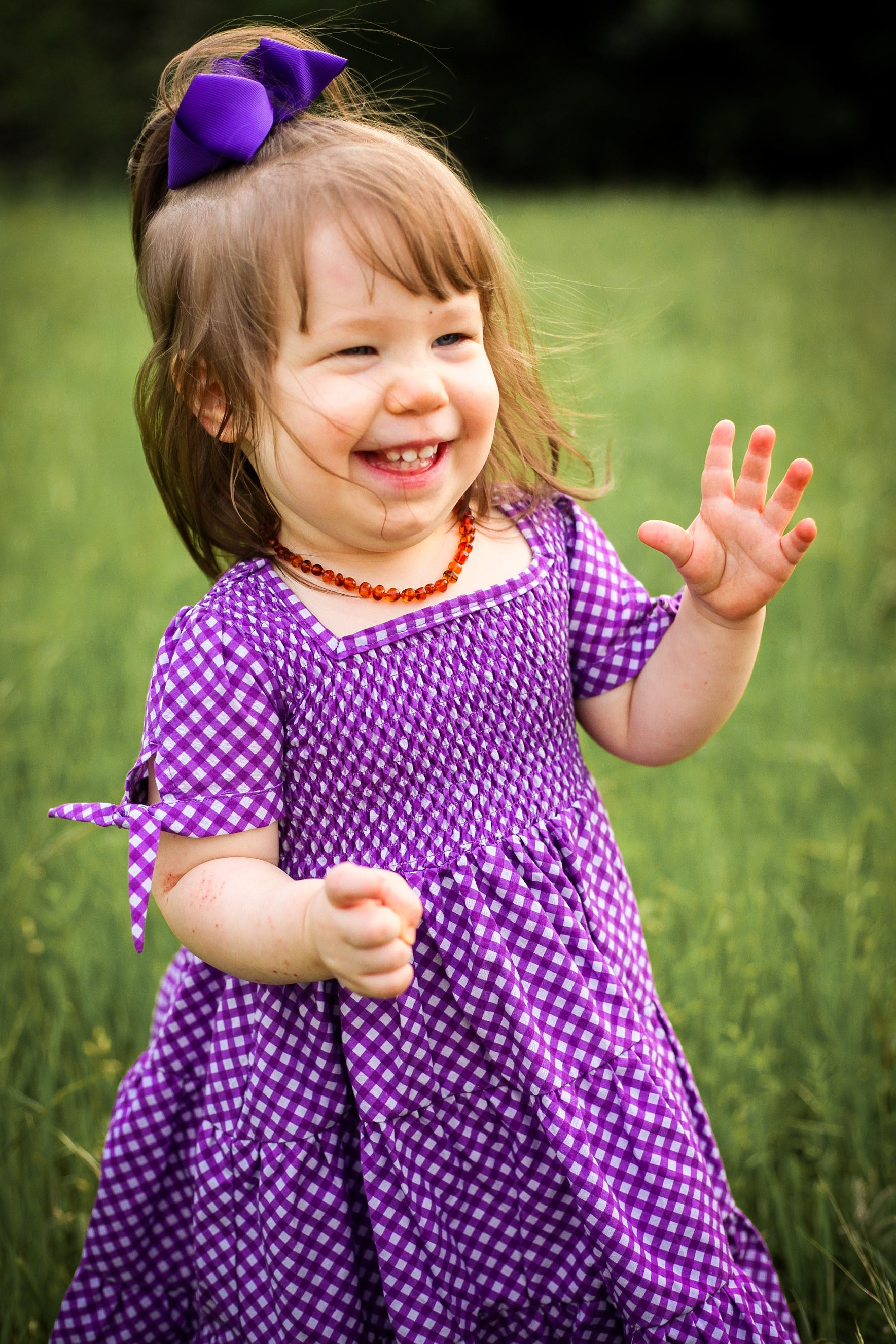 Young girl wearing a modest purple dress