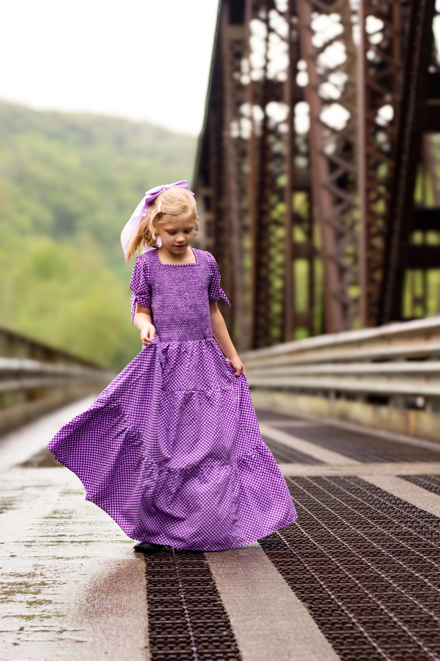 Young girl wearing a modest purple dress