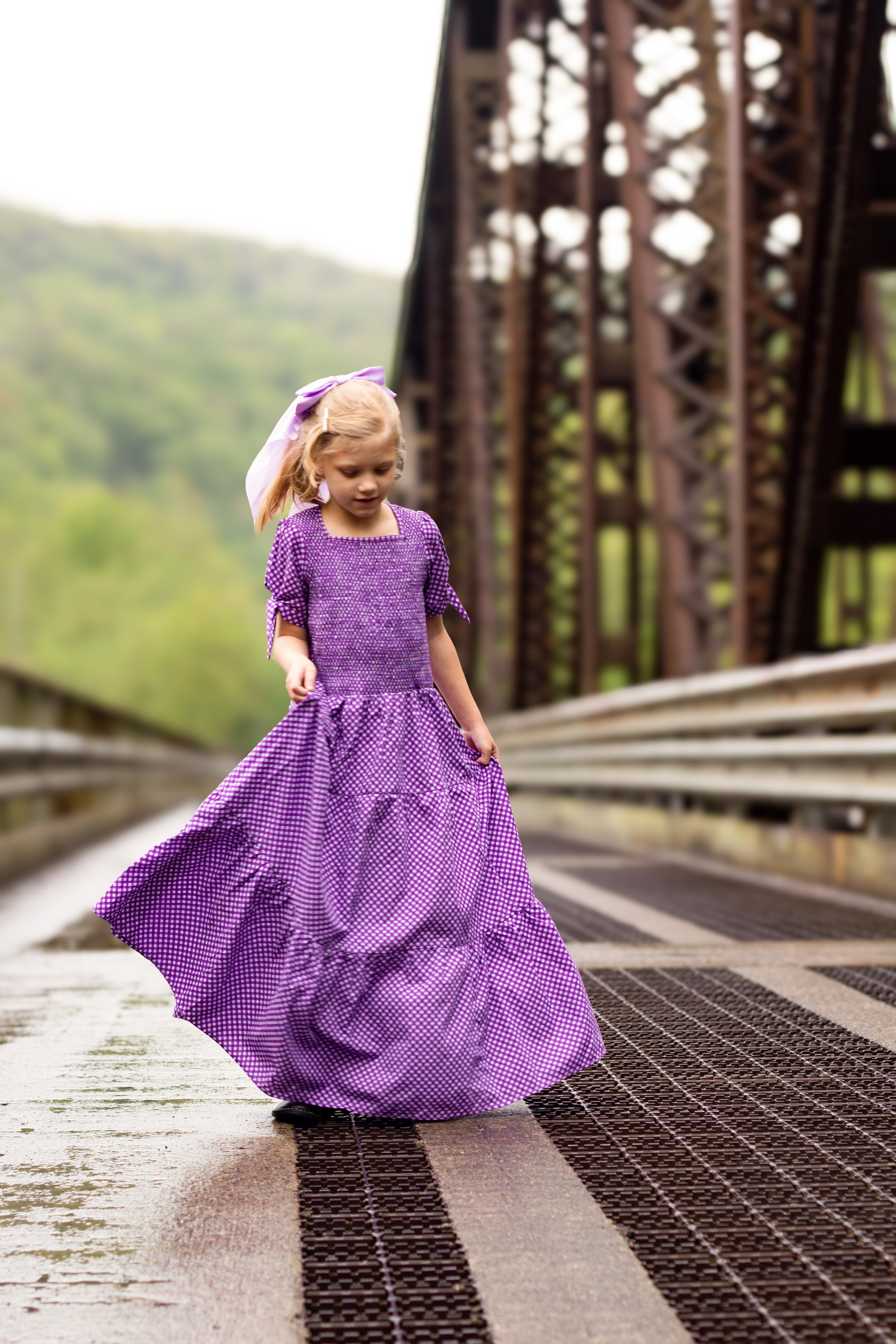 Young girl wearing a modest purple dress