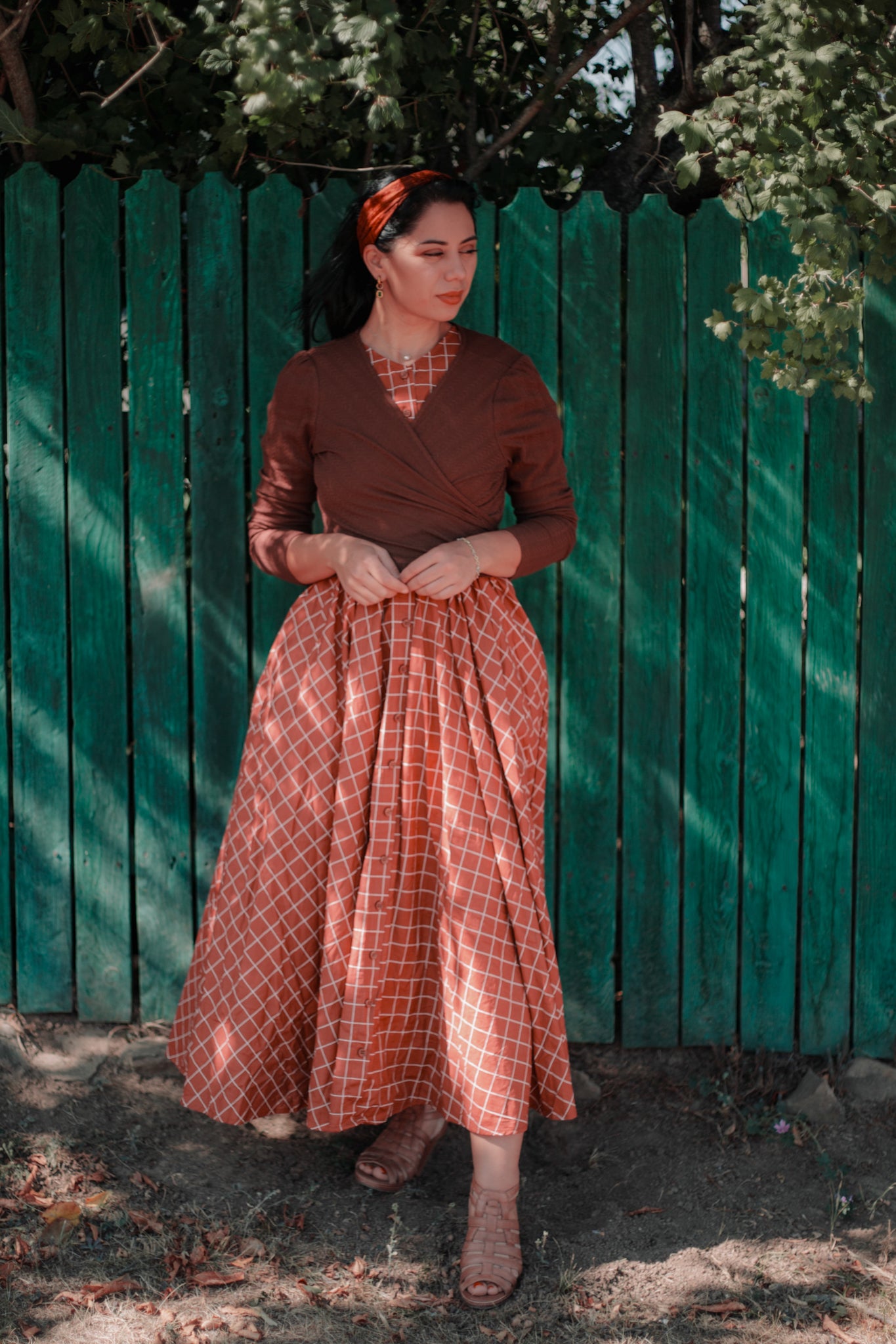 Woman in modest nursing brown dress outdoors