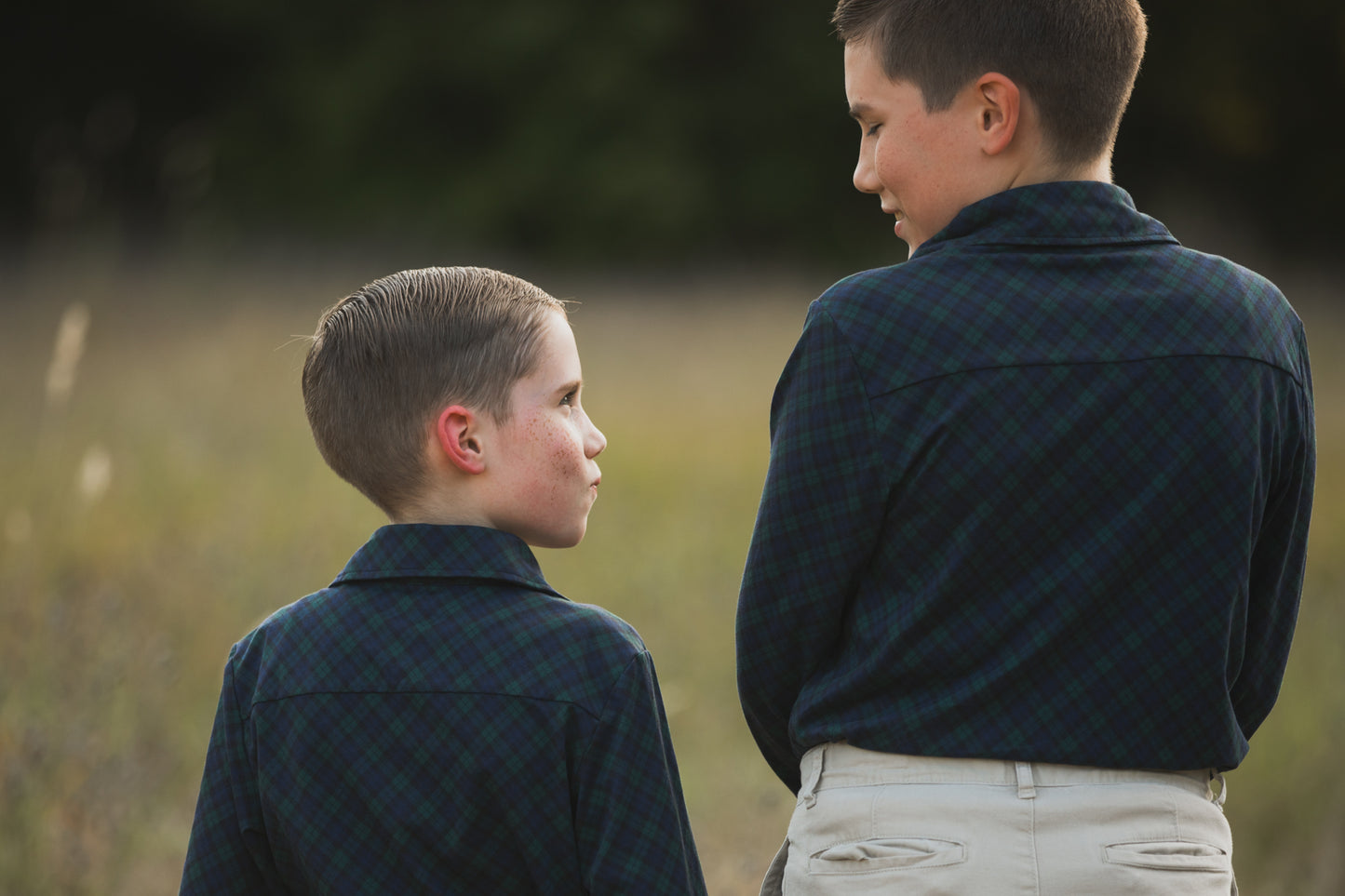 Two boys in plaid shirts outdoors