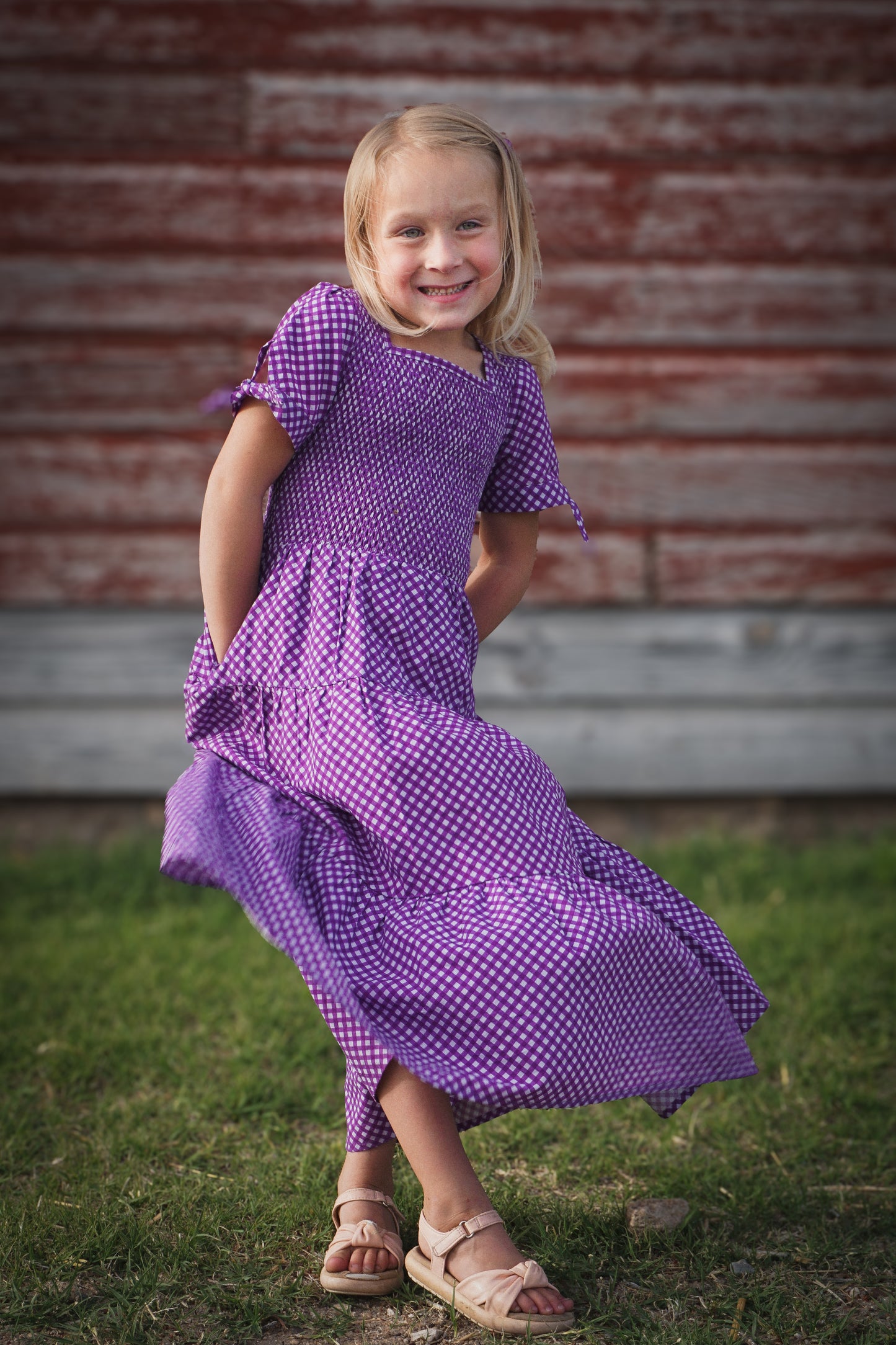 Young girl wearing a modest purple dress