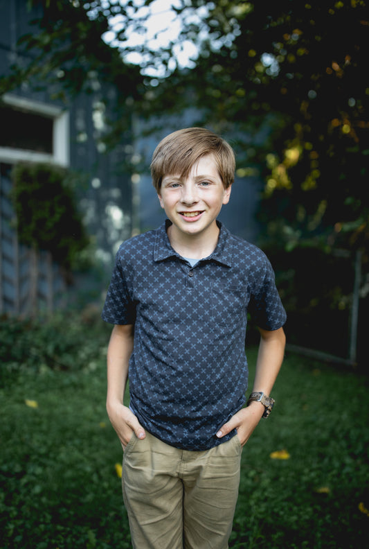 Young boy wearing a dark blue polo