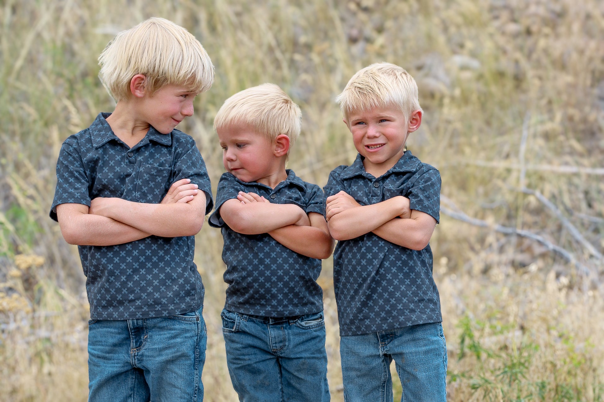 Young boys wearing a dark blue polo shirt