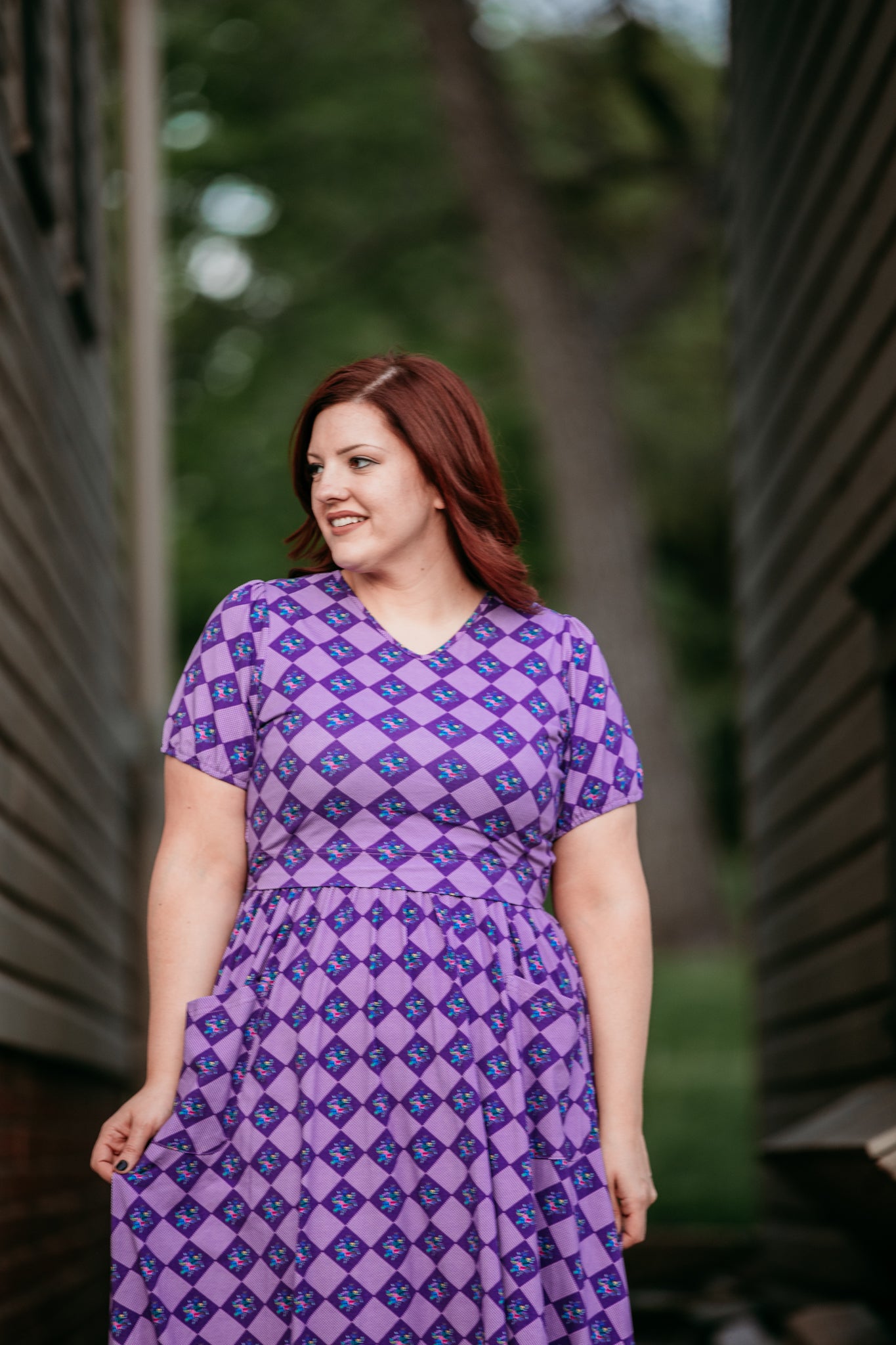 woman wearing patterned purple modest nursing dress