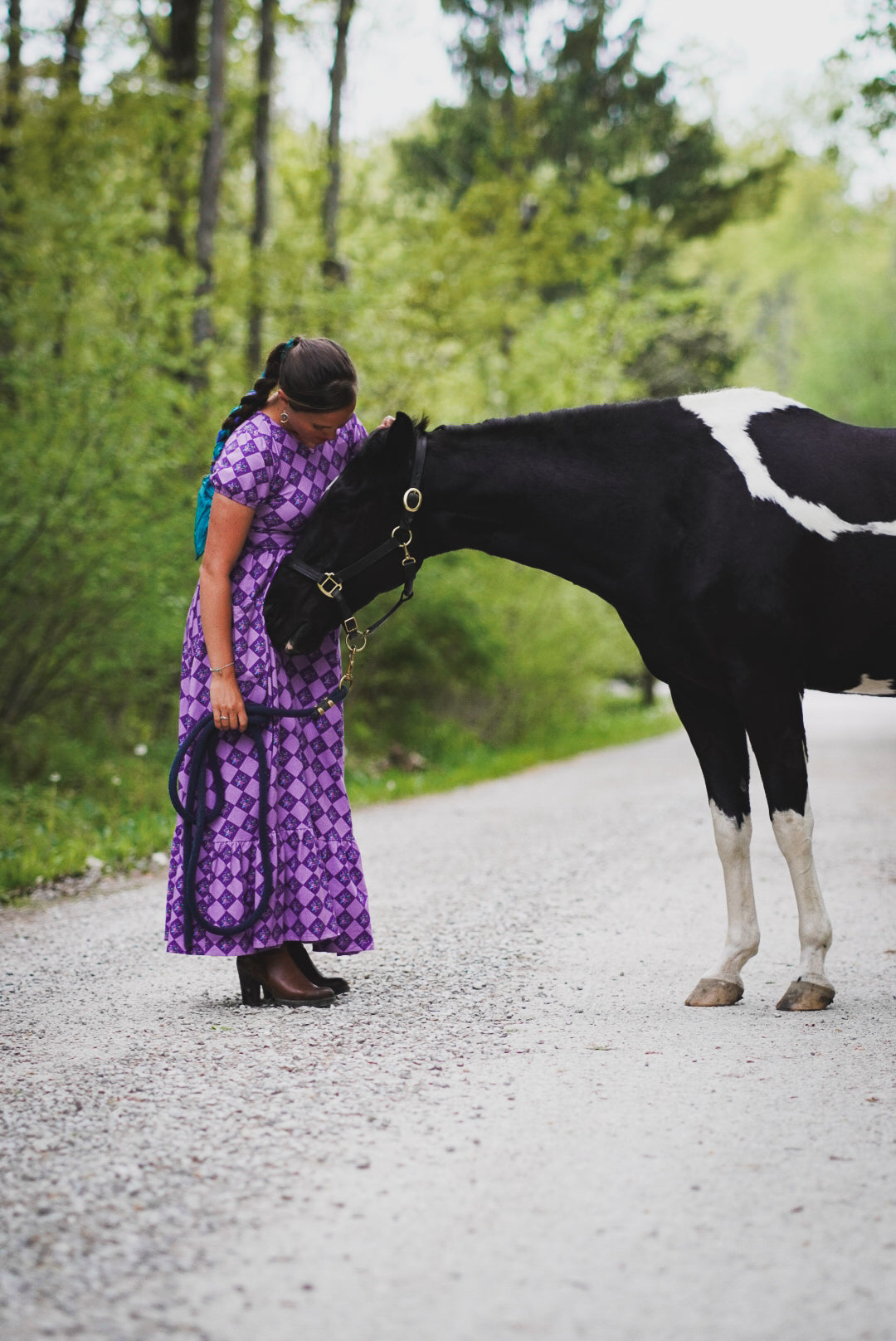 woman wearing patterned purple modest nursing dress
