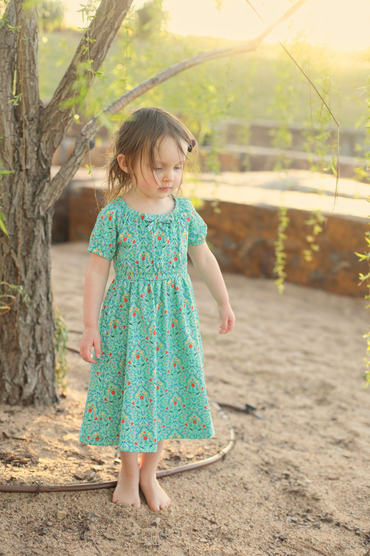 Young girl wearing a modest green dress