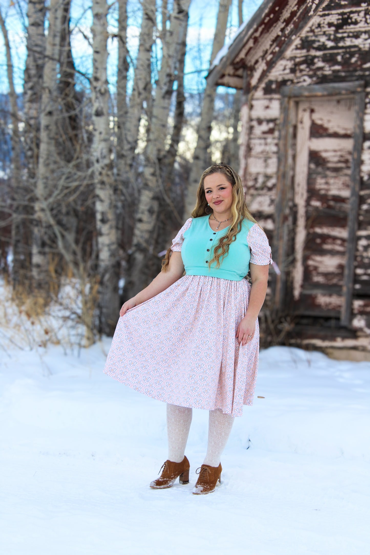 A woman wearing a vintage style modest nursing dress.