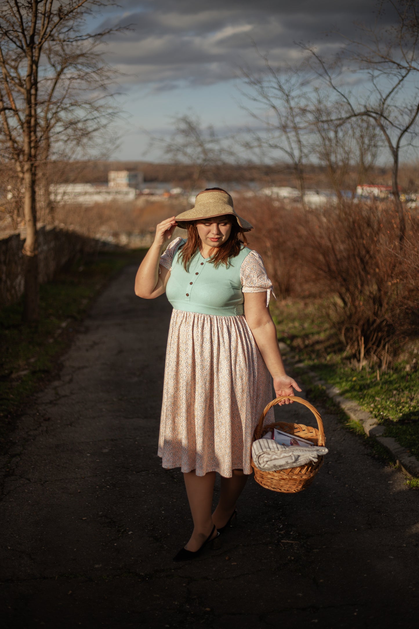 A woman wearing a vintage style modest nursing dress.