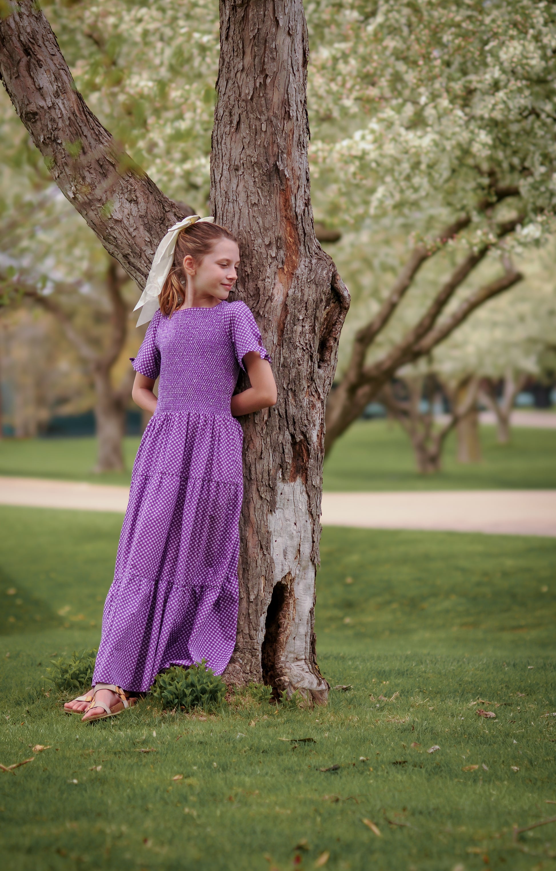 Young girl wearing a modest purple dress
