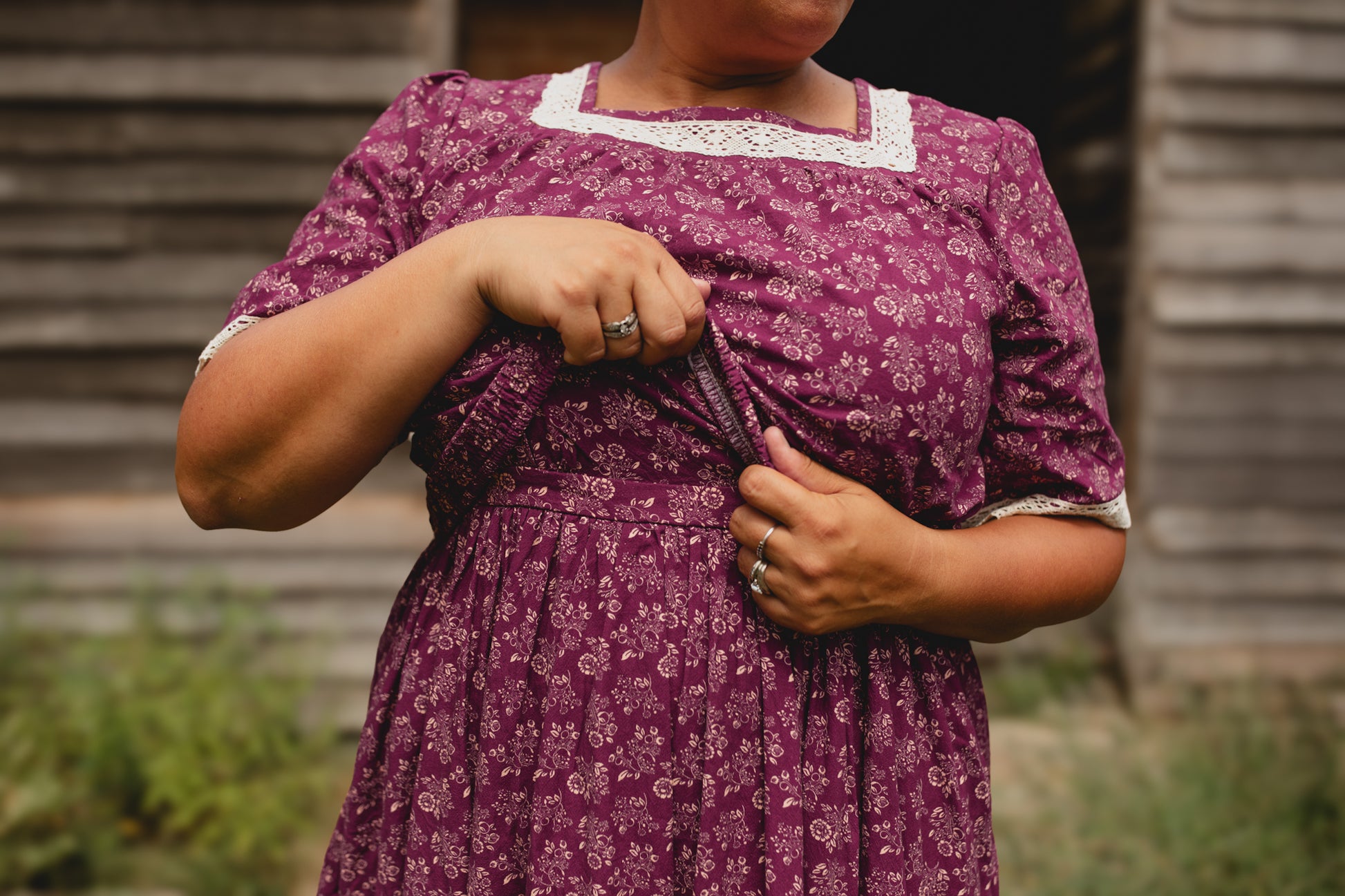 Person wearing modest purple floral nursing dress outdoors