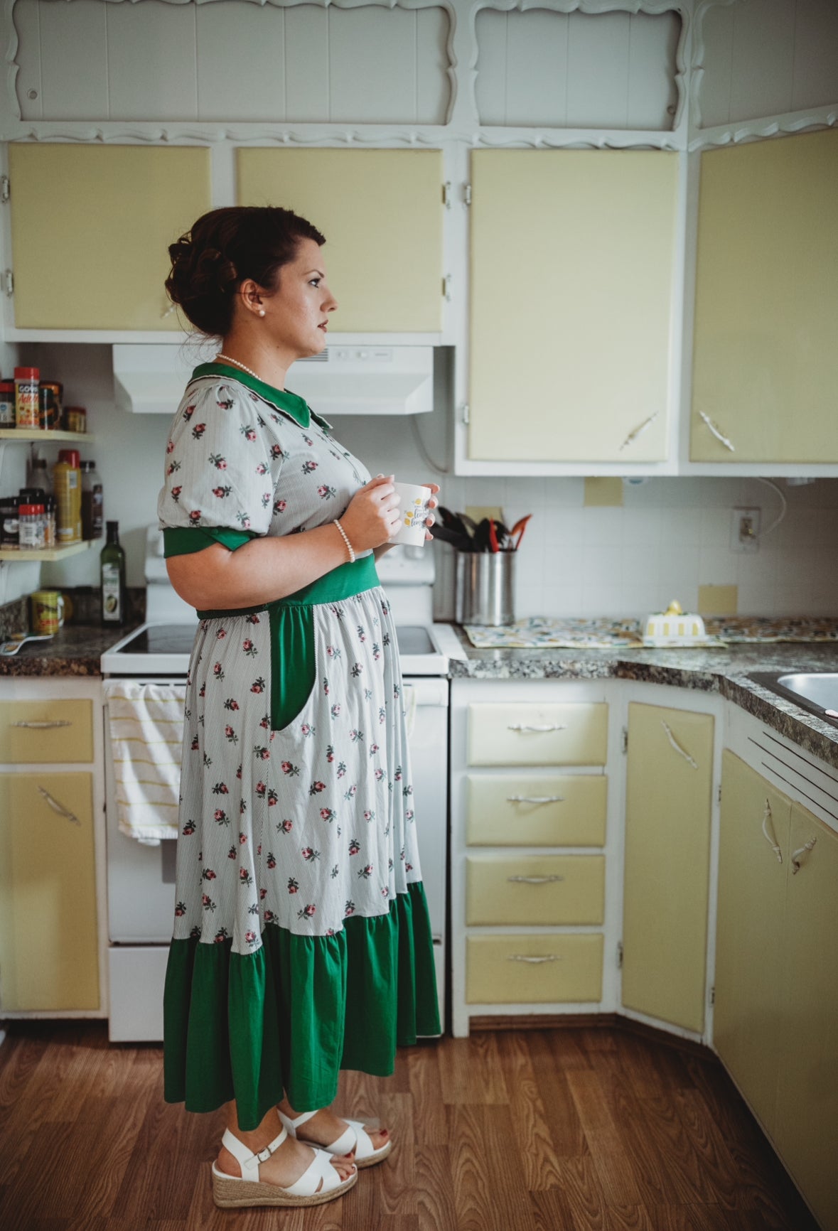 woman wearing a green and white striped modest nursing dress