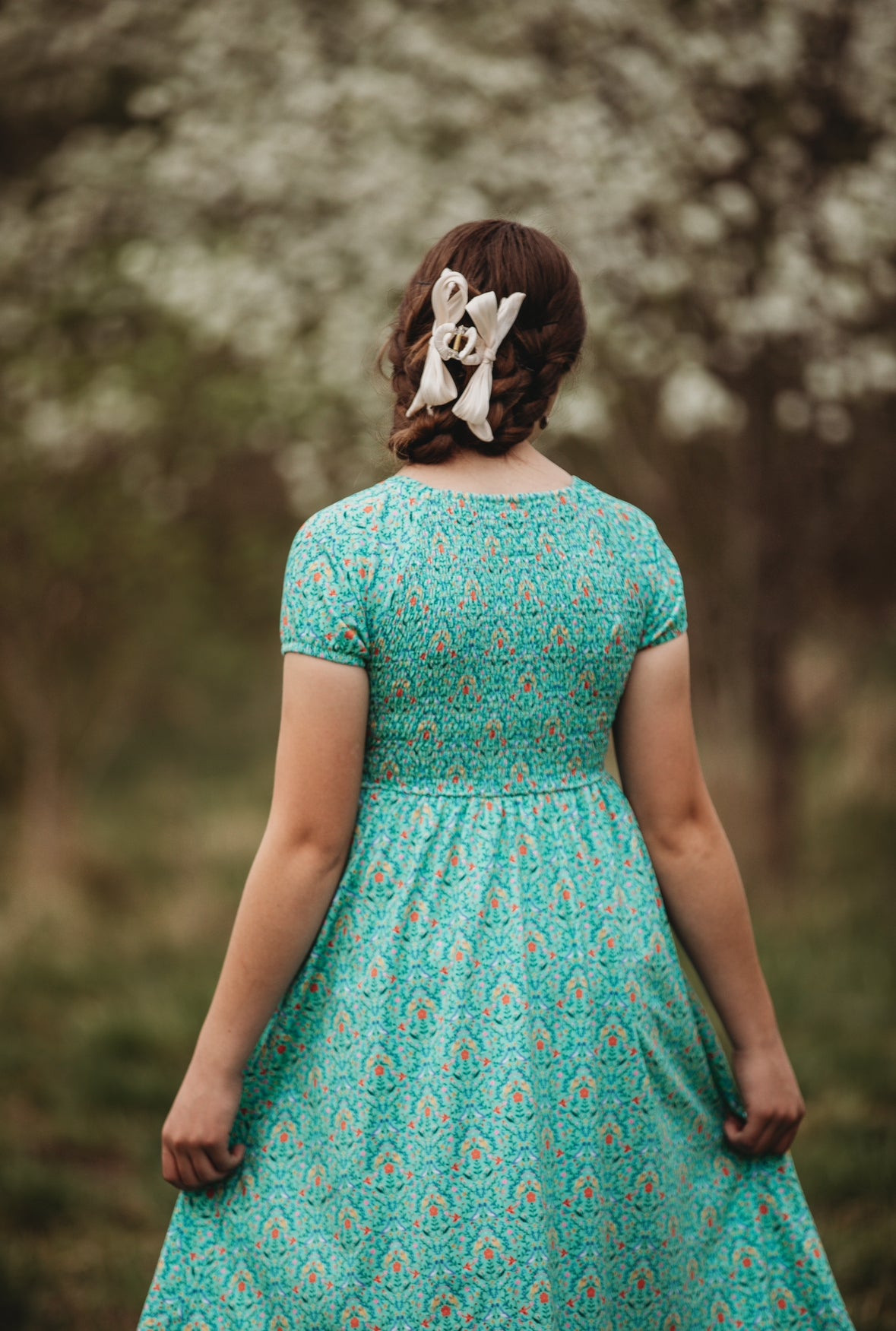 Young girl wearing a modest green dress