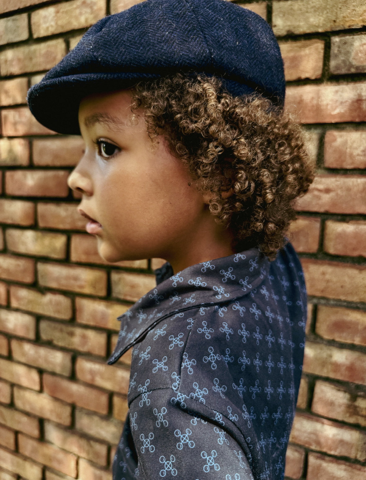 Young boy wearing a dark blue polo shirt