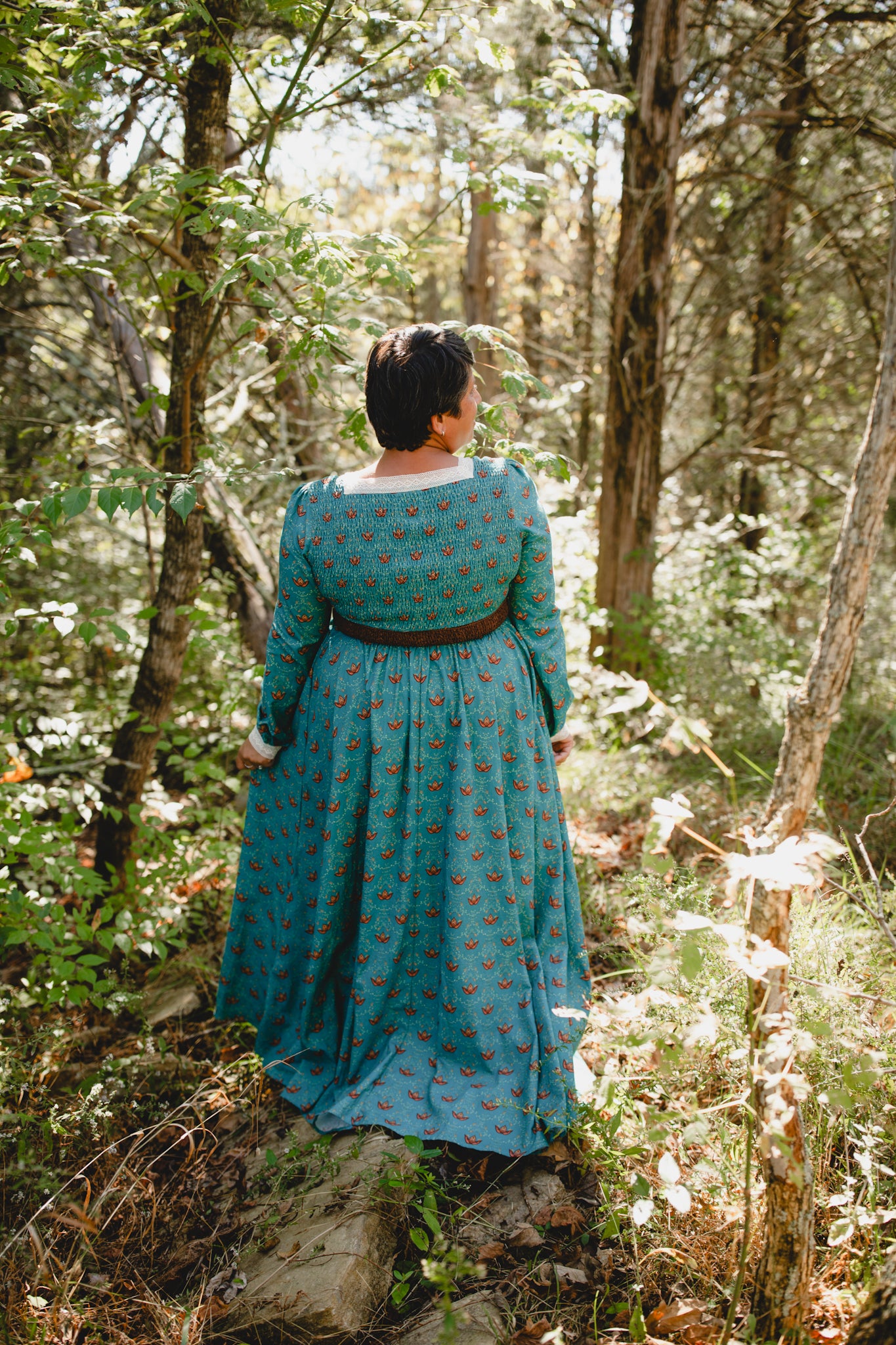 Woman in modest nursing teal patterned dress outdoors