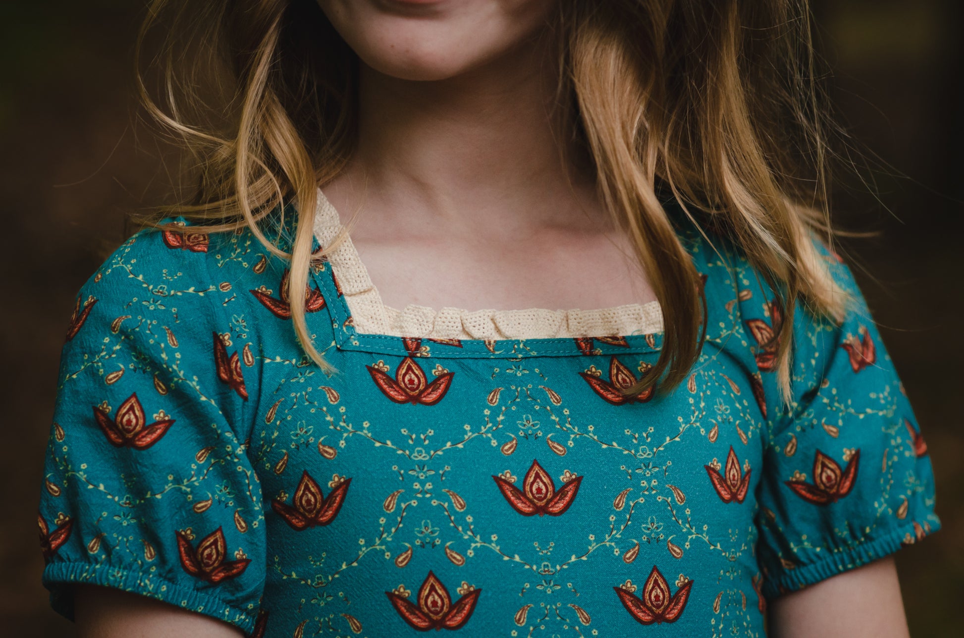 Close-up of modest nursing dress with floral patterns.