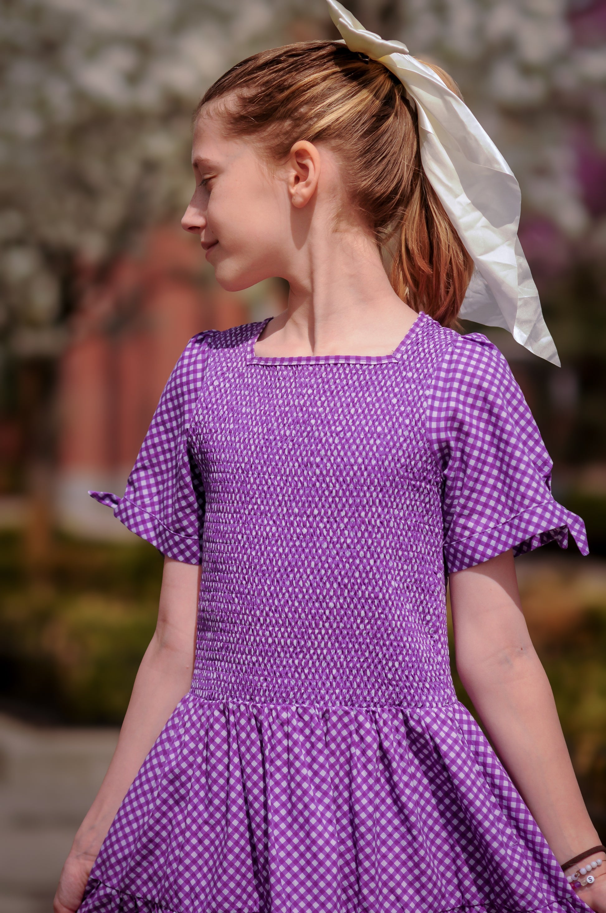 Young girl wearing a modest purple dress