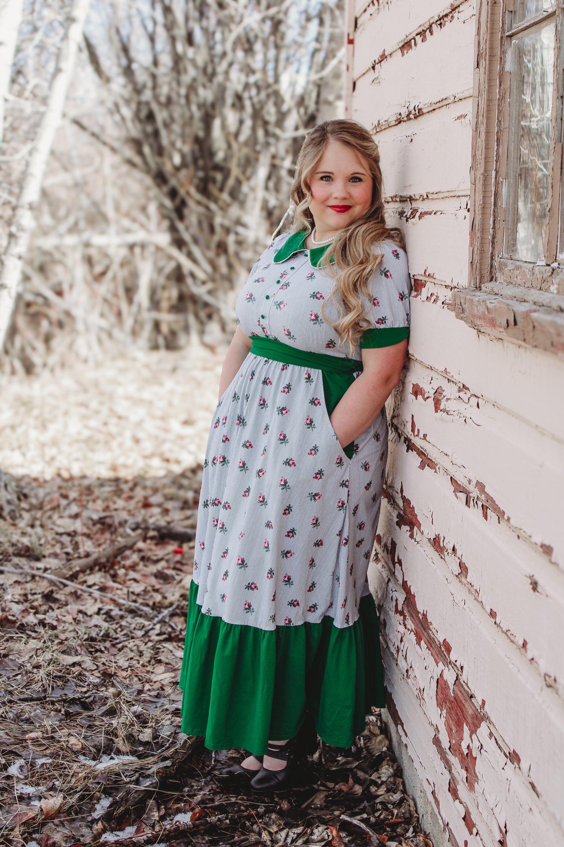 woman wearing a green and white striped modest nursing dress