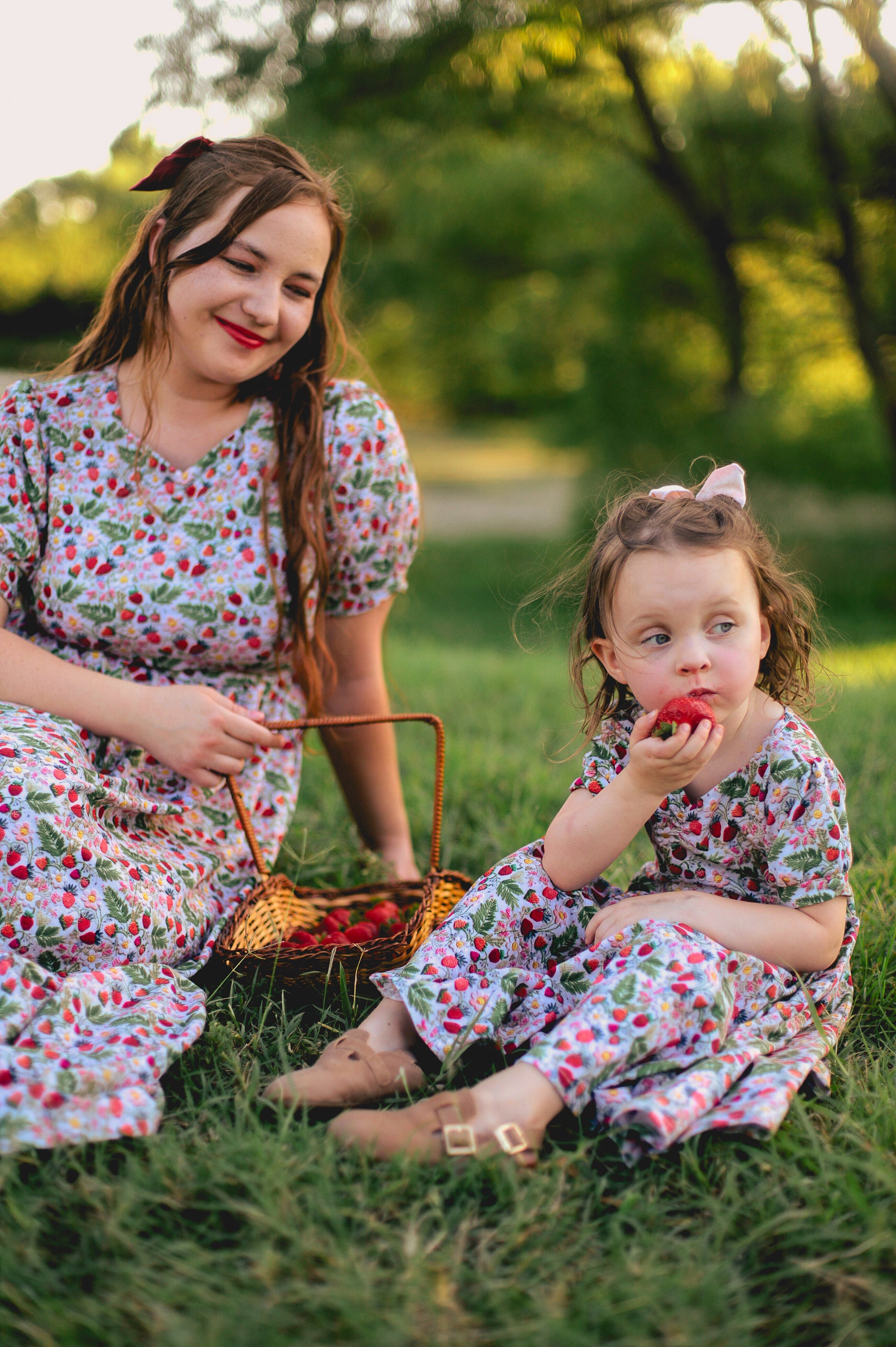 Woman in a floral modest nursing dress with her daughter.