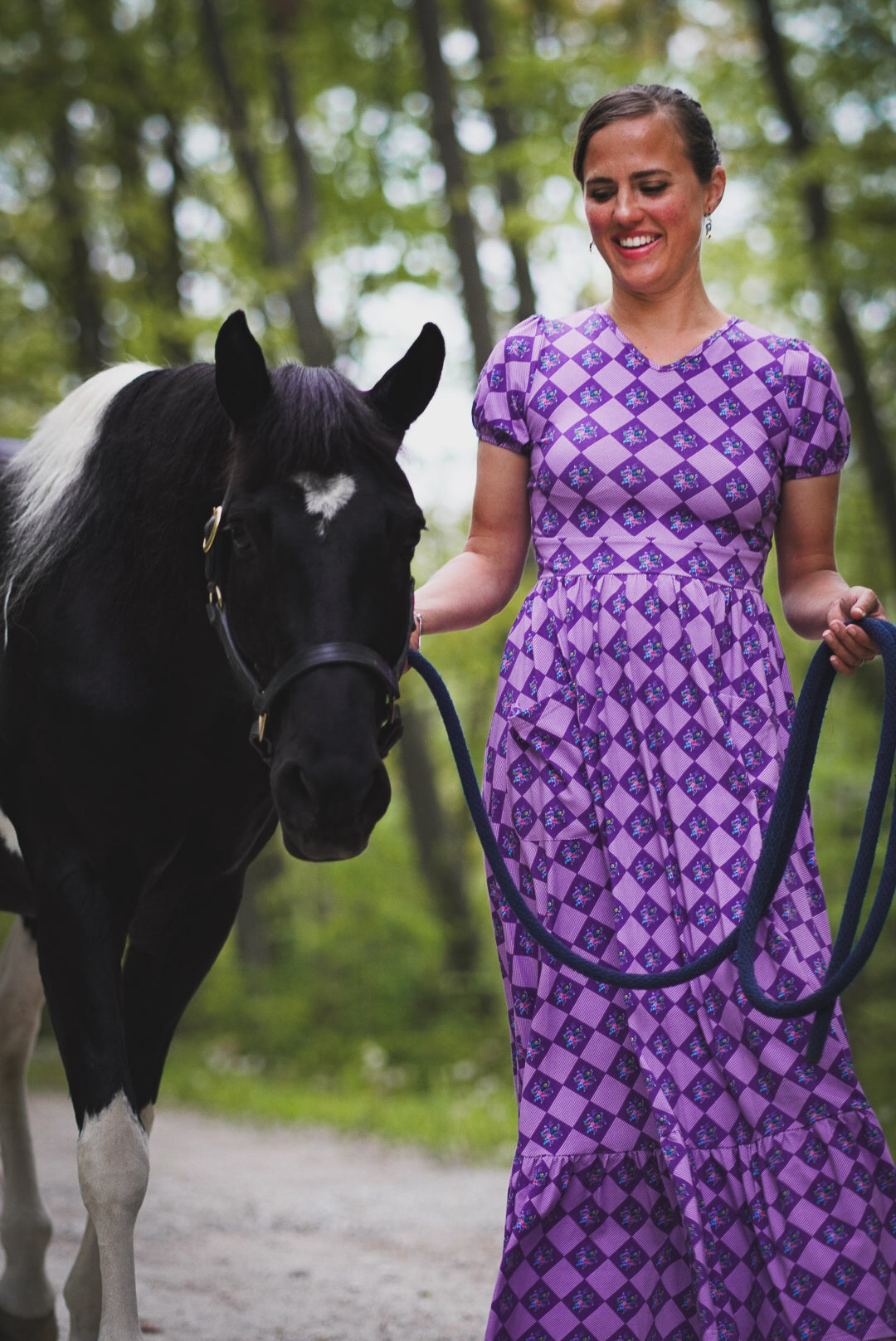 woman wearing patterned purple modest nursing dress