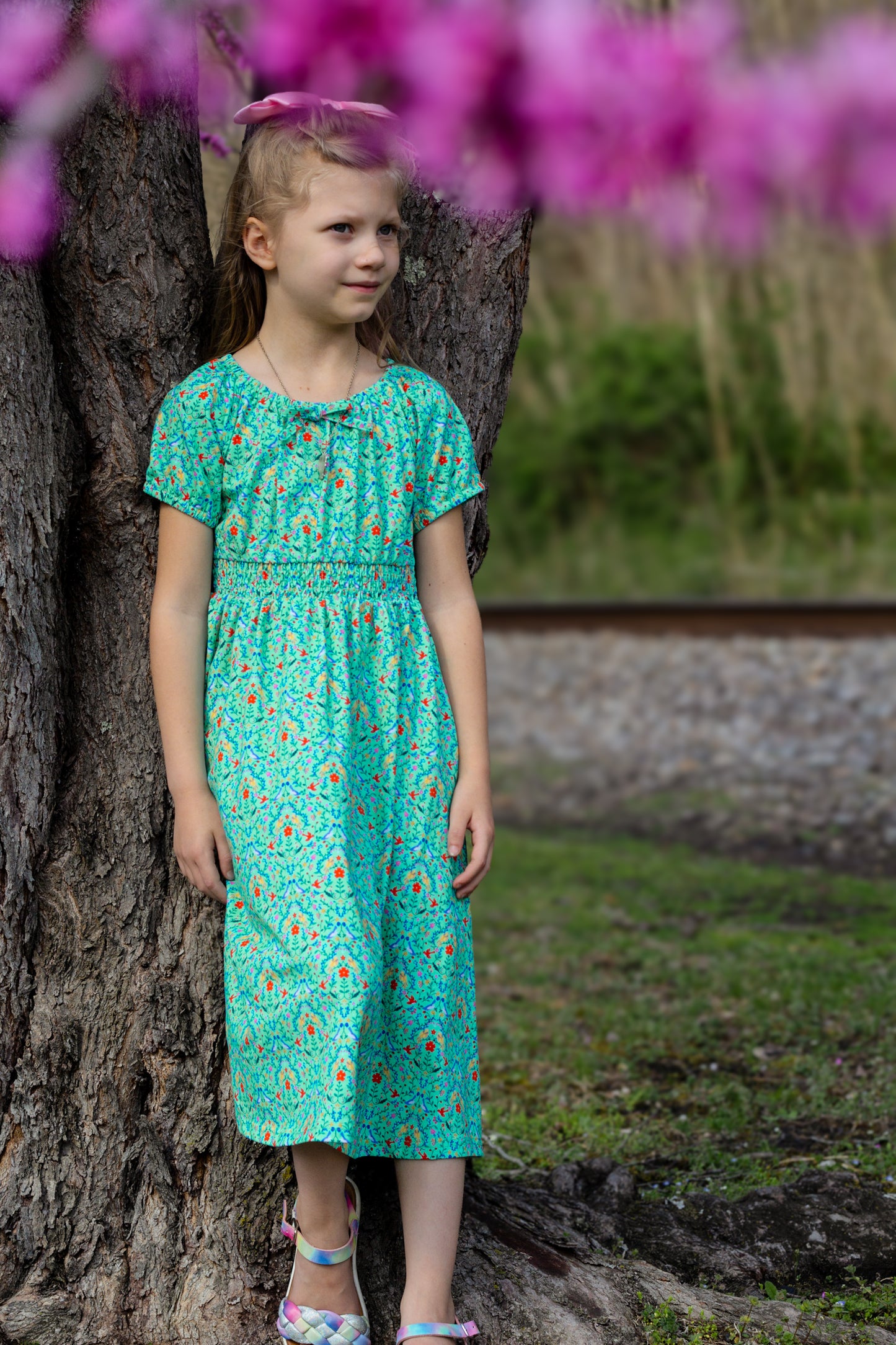 Young girl wearing a modest green dress