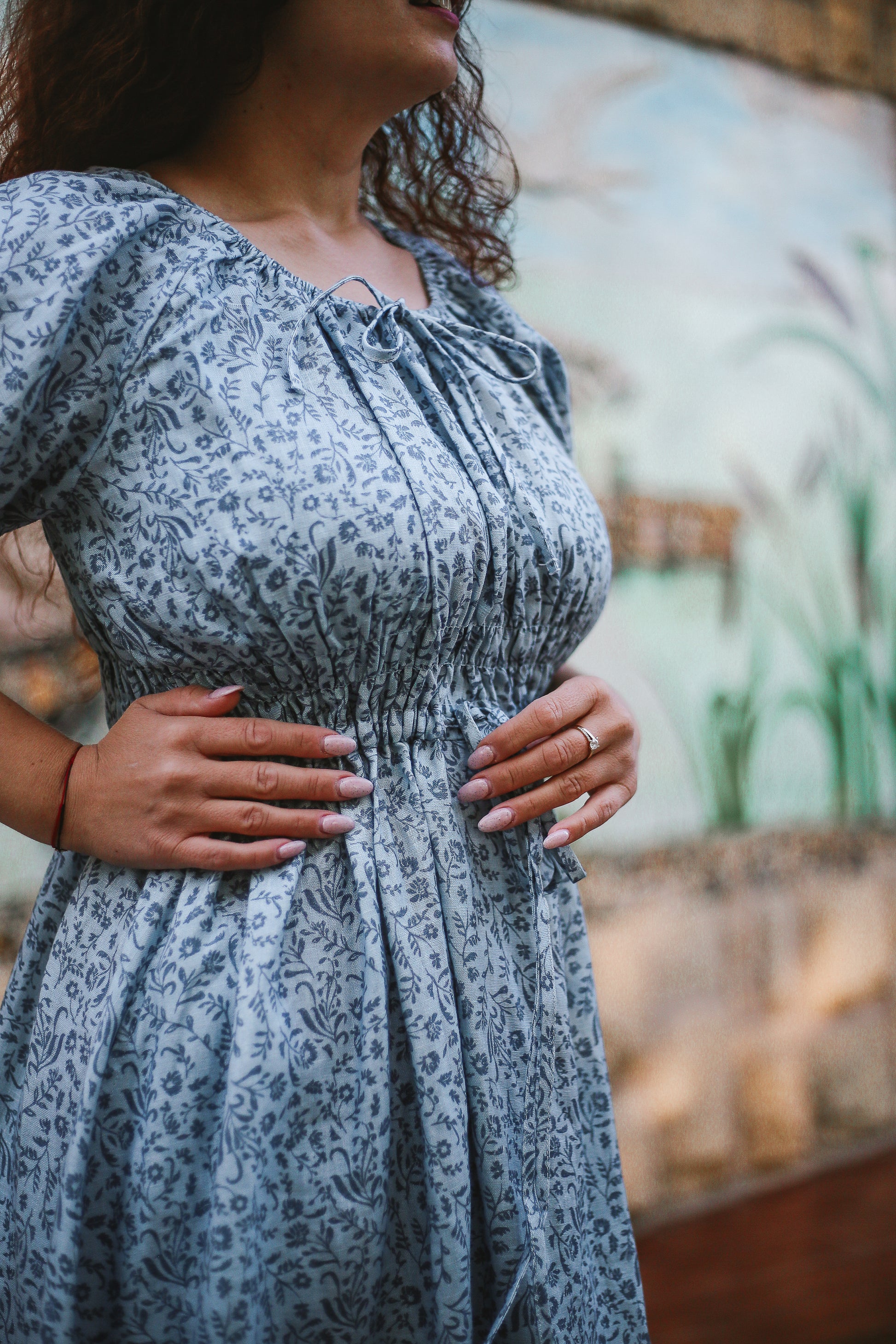 woman in a modest blue nursing dress