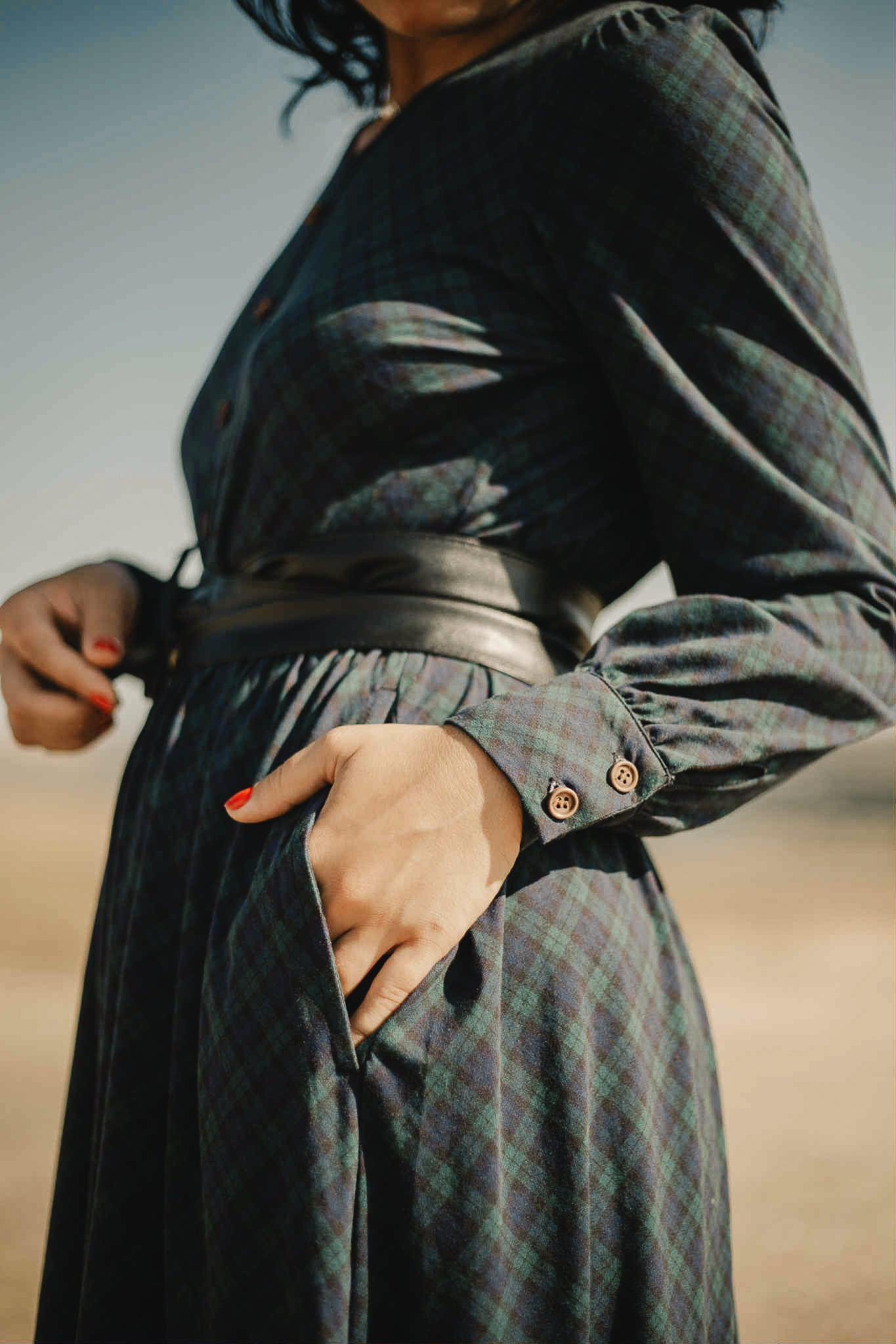 Woman in modest nursing dark plaid dress