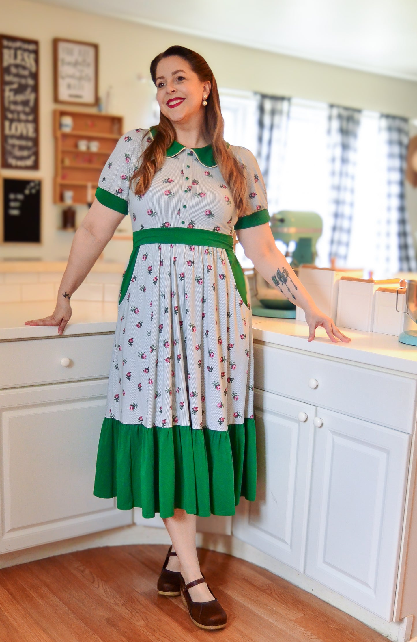 woman wearing a green and white striped modest nursing dress
